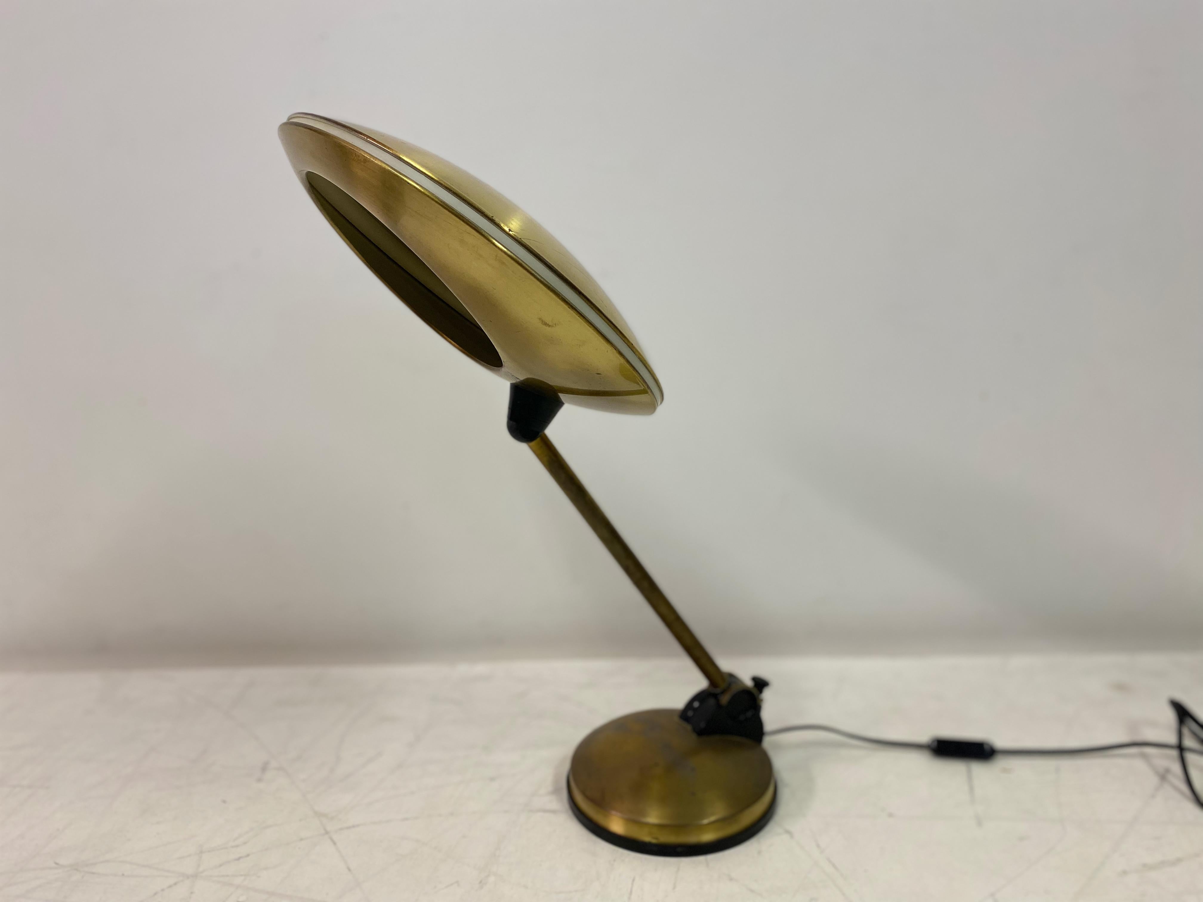Desk or table lamp

Brass

Saucer shaped shade

Stem can be angled from base

Shade is also adjustable

1960s/1970s Italian.