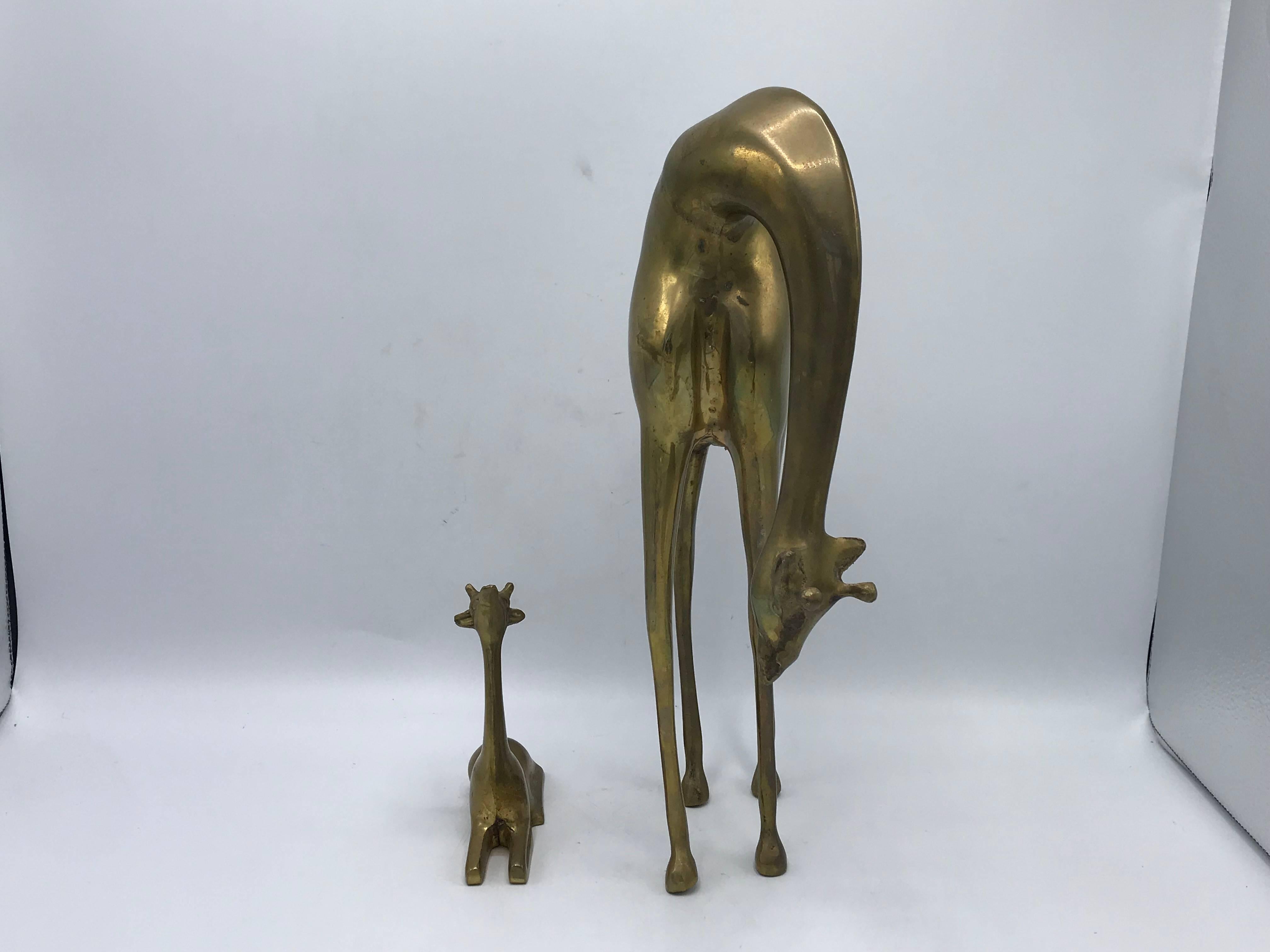 Listed is a gorgeous, pair of 1960s Italian brass giraffe sculptures. Heavy.

Measures: Large (standing): 14.75 H x 10 W x 4.75 D
Small (sitting): 5.5 H x 4.75 W x 1.75 D.