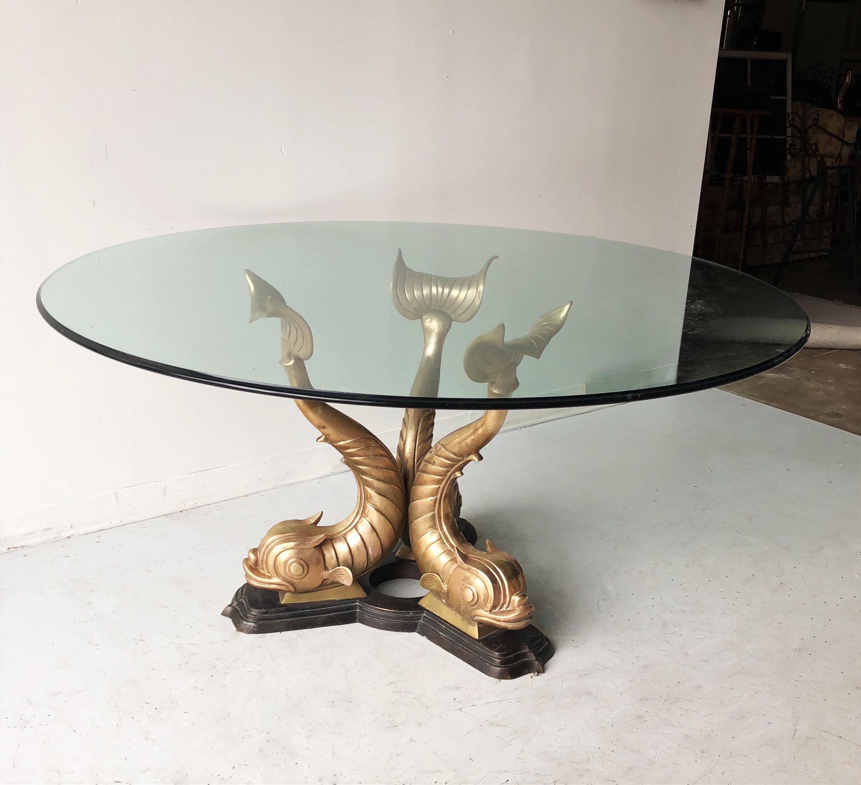Incredible koi fish dining table. Table base depicts three sculptural brass Koi fish resting on a bronze base. Made in Italy. Extremely heavy and sturdy base that can withstand a very large heavy piece of glass. It does not come with glass, but we