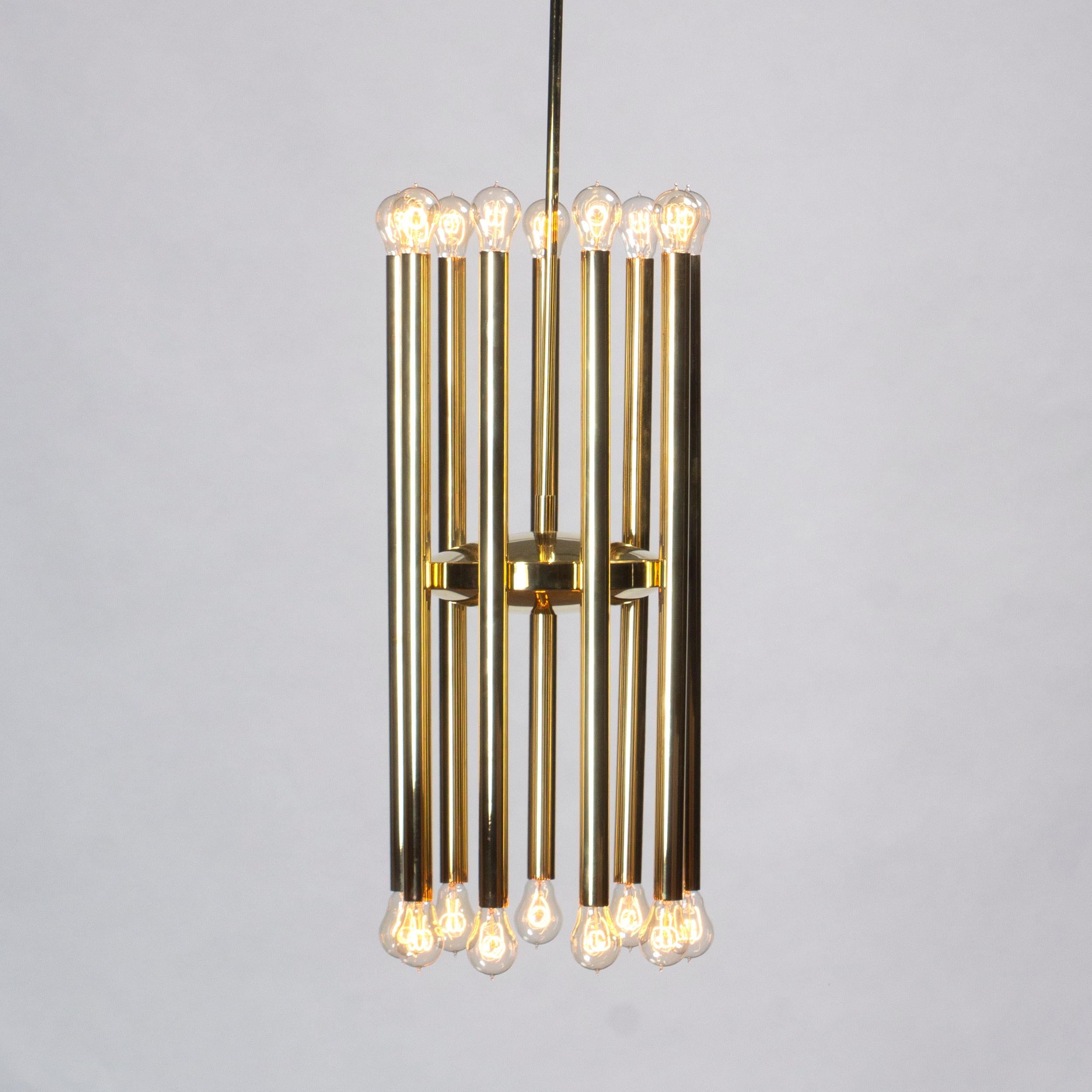 A dramatic brass ceiling fixture with nine adjustable tubes encircling a brass disc.  