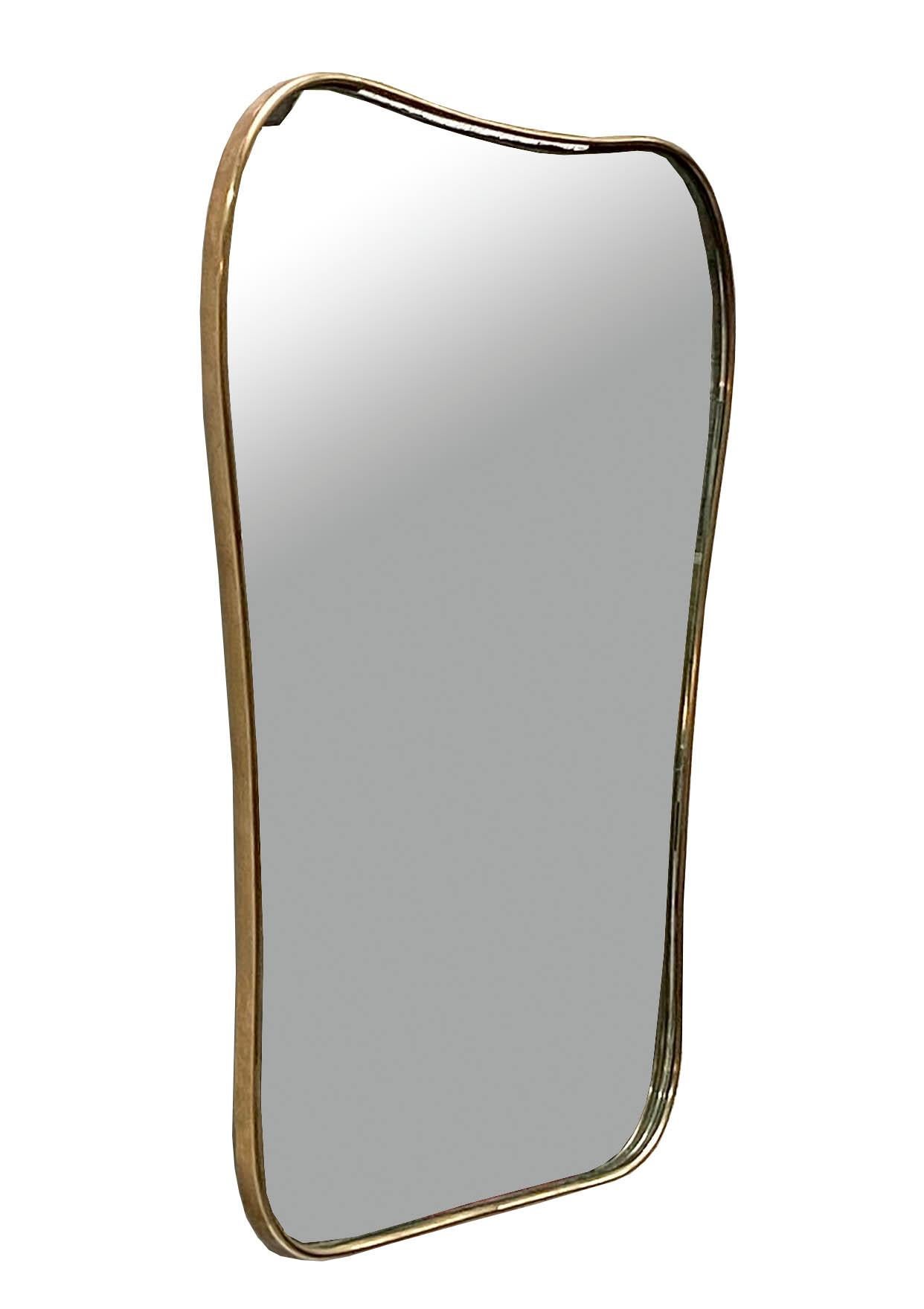 Beautiful Italian brass mirror from circa 1960s in a beautiful design. The mirrored glass is original, and the piece is stylistically related to the work of noted designer Giò Ponti.
The gentle, well-proportioned shape gives this mirror a touch of