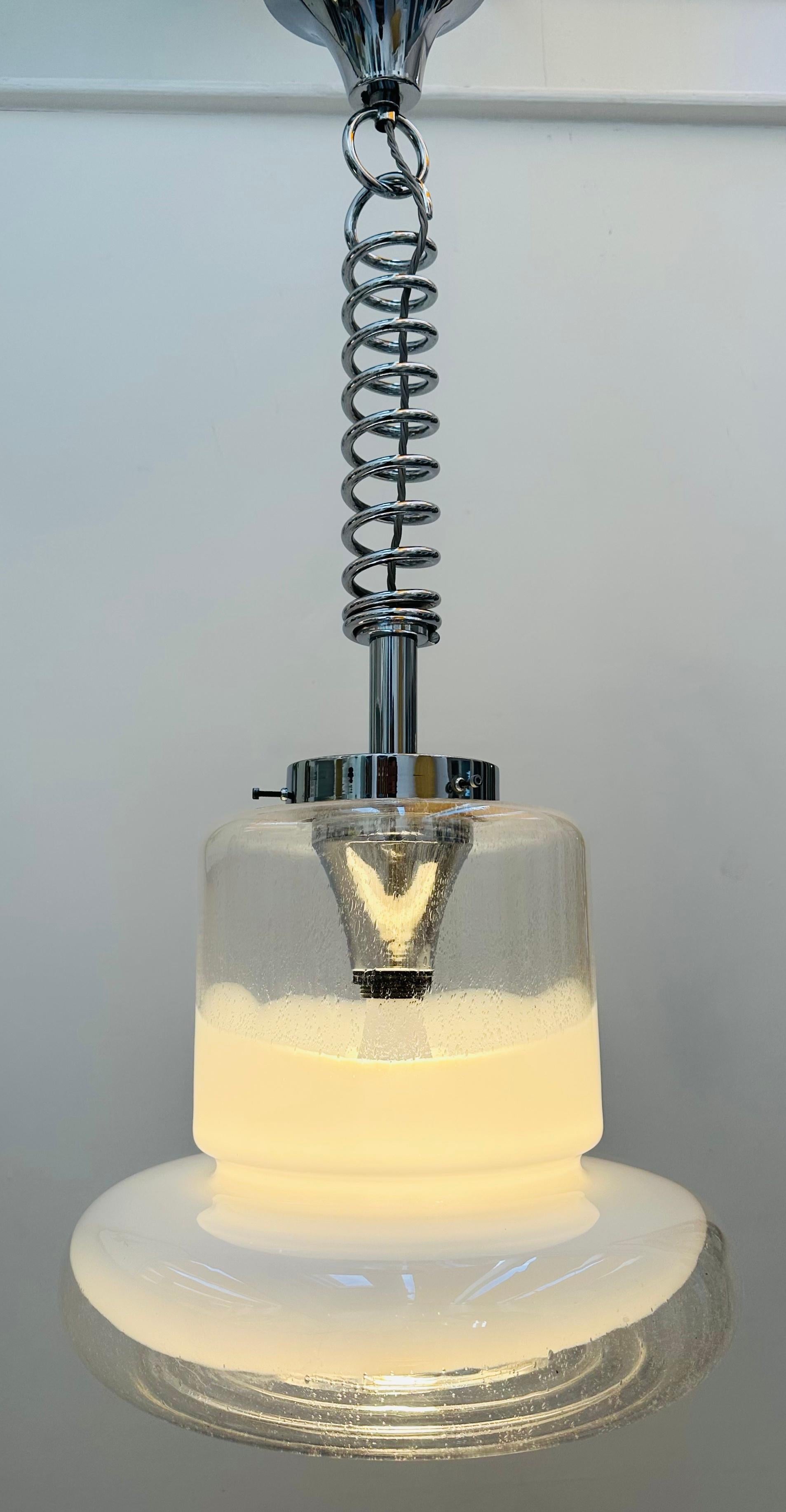 1960s Italian Murano glass ceiling pendant light designed by Carlo Nason for Mazzega.  A beautifully designed and futuristic design with clear glass at the top of the cylindrical shade with a wider bulbous ring. An opaque white swirled design around