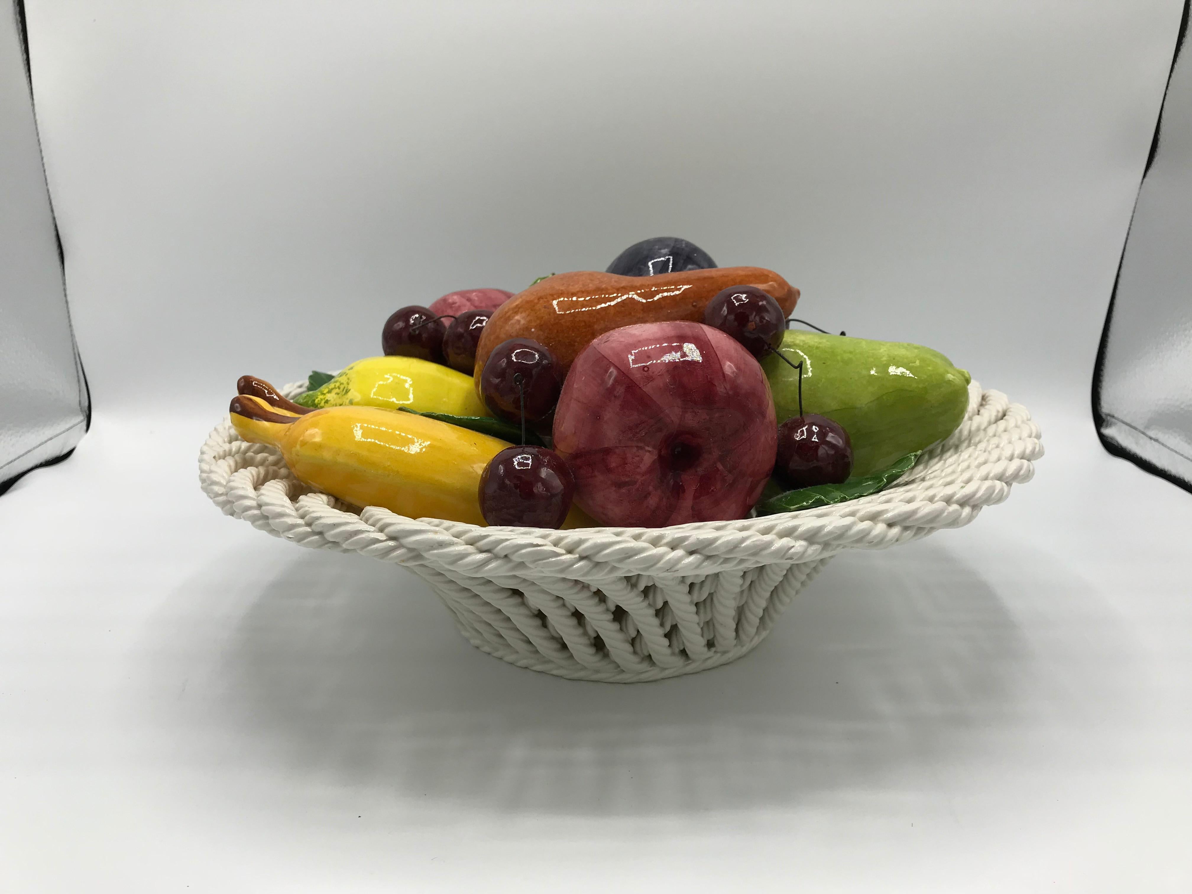 Offered is a fabulous, 1960s Italian ceramic fruit basket sculpture. The piece is in incredible condition, considering its age -- no chips or breaks along the basket and all fruit is secure. Heavy, weighing 7lbs. Marked 'Made in Italy' on underside.