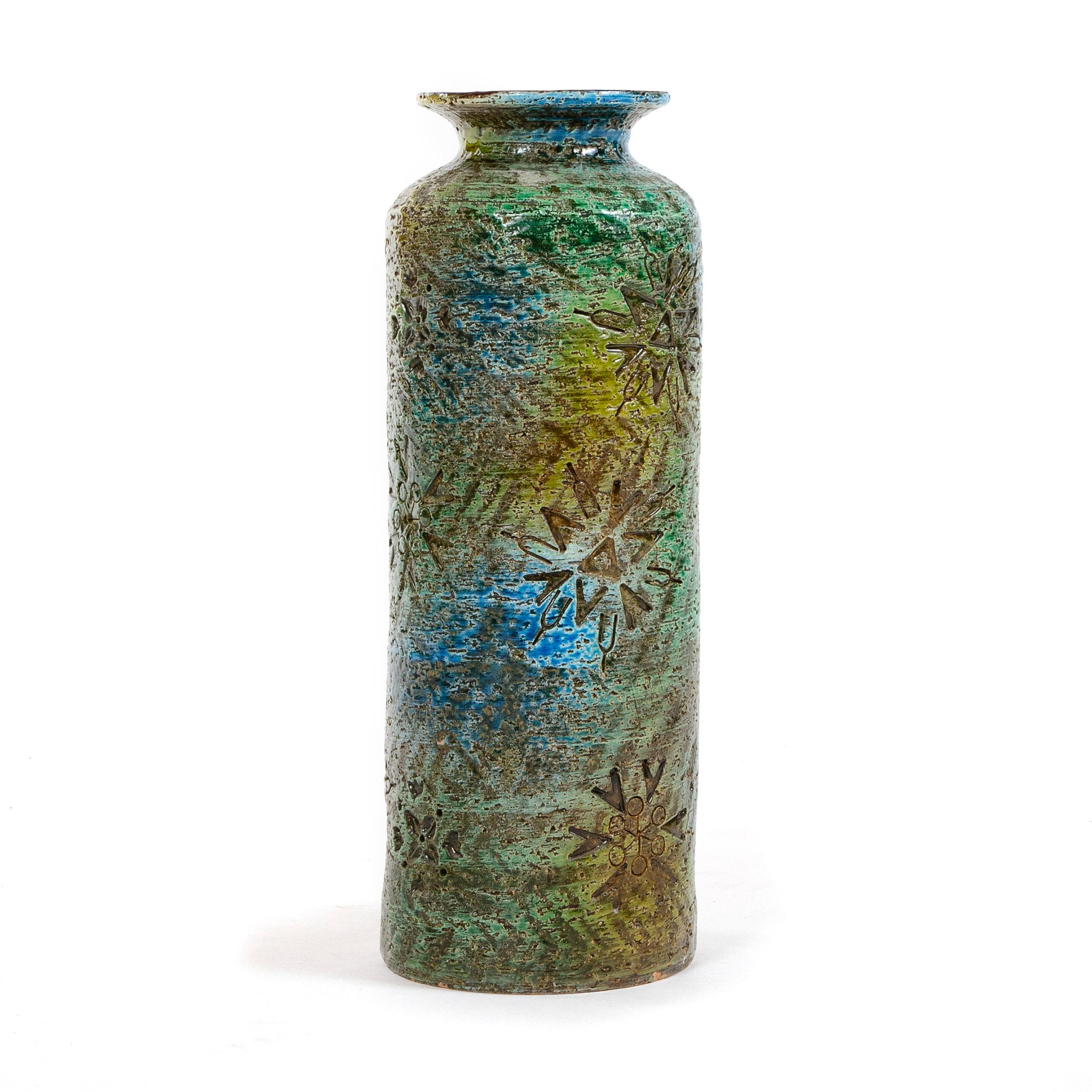 A warm multicolored embossed ceramic vase.