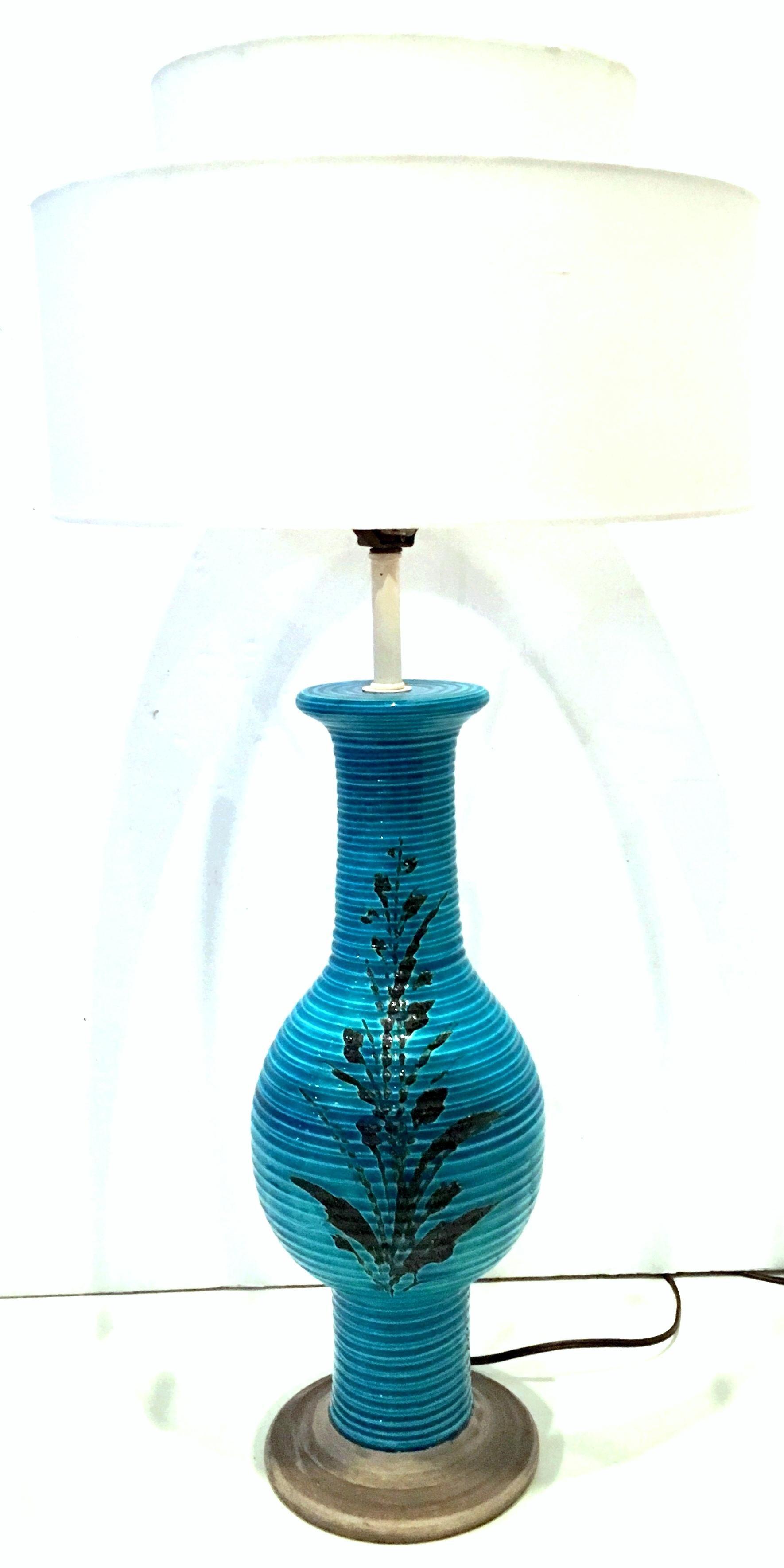 1960s Bitossi for Raymor Coveted Italian handcrafted, two-tone cerulean blue and black hand painted, double sided floral motif ceramic pottery lamp signed and numbered. The faux bois finished base is made of ceramic. The neck and socket, harp and