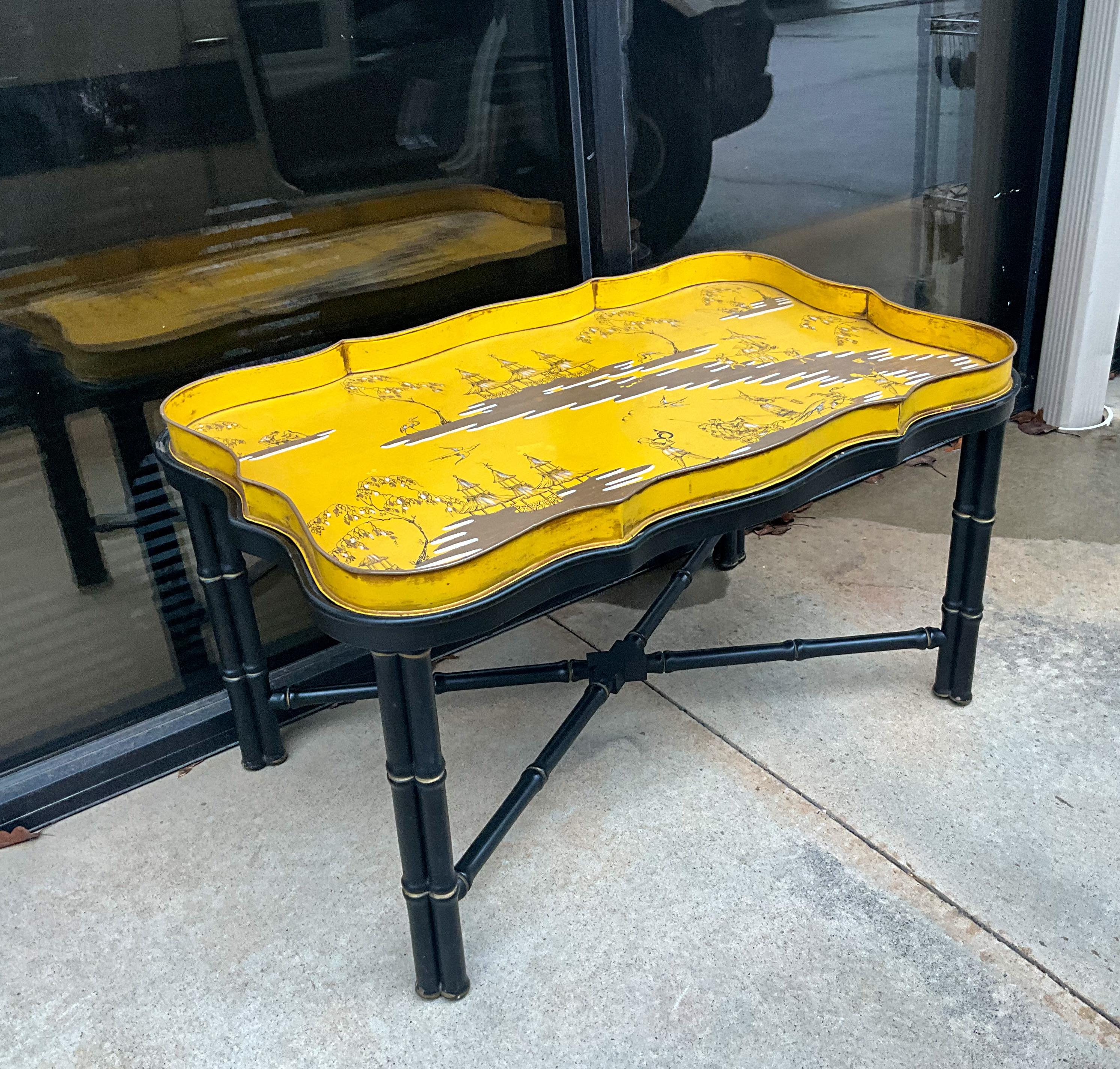 This is a fun piece! It is a yellow Italian chinoiserie tole tray table on a black faux bamboo tray table. The tan and base are separate pieces, and it is marked. Brighten any space with this one!