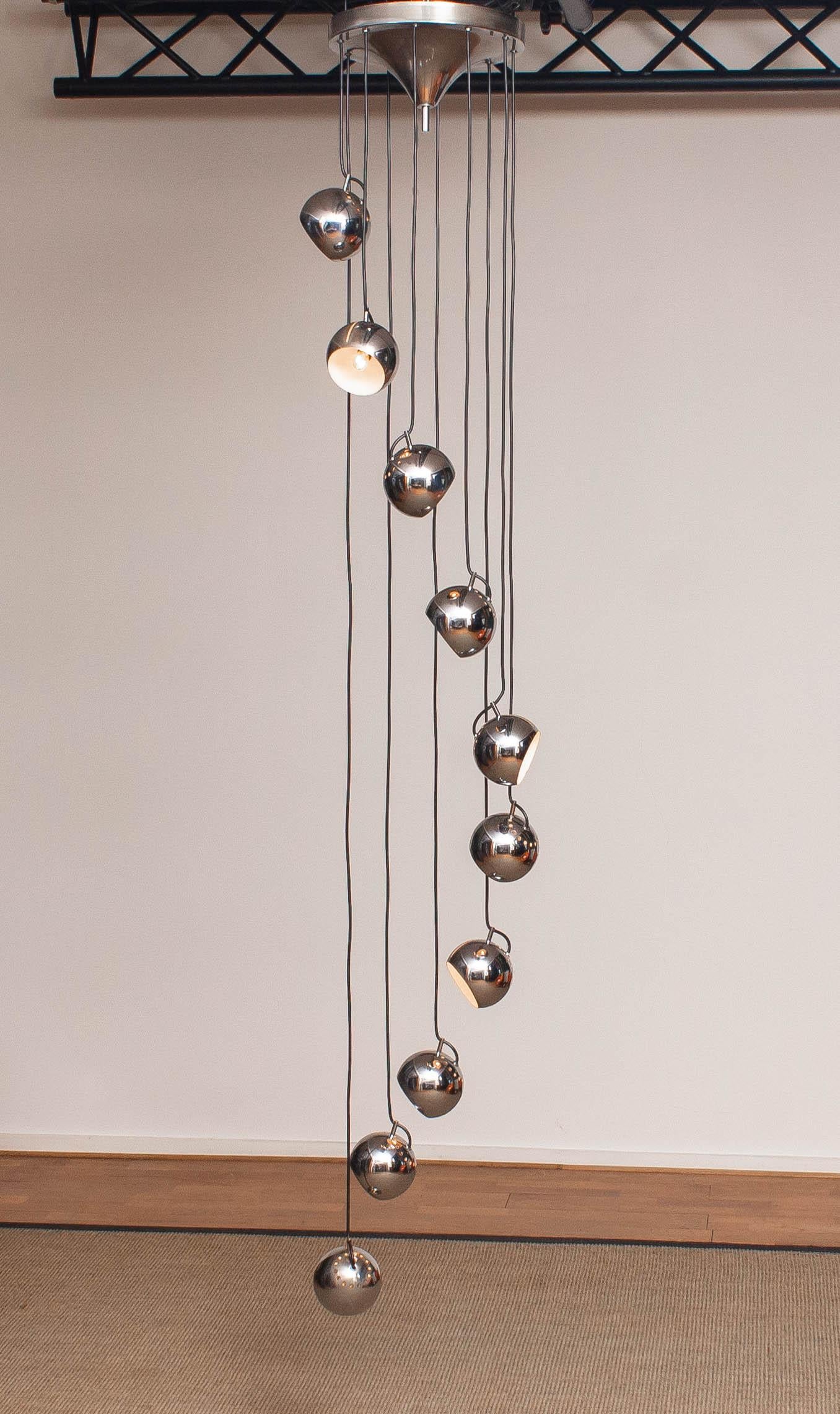 Beautiful cascade by Harvey Guzzini for Meblo filled with ten chromed perforated and adjustable spherical lights all in original and good condition. Each spherical light consists a screw fitting, Size E14, consisting 110 as well as 230 volts. 
This