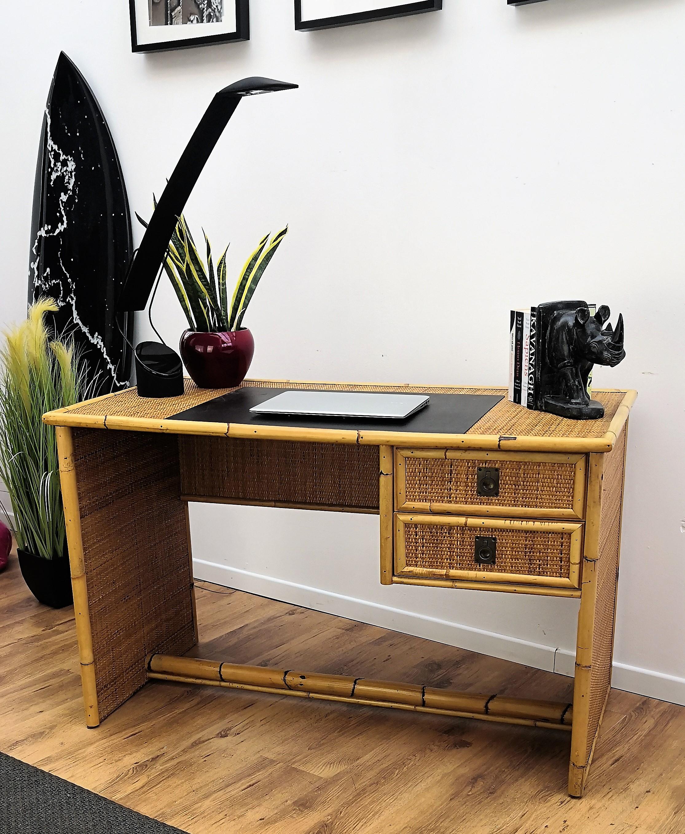 Beautiful 1960s Italian Mid-Century Modern writing table or desk in bamboo and wicker rattan with 2 side drawers with typical brass handles from renowned Dal Vera manufacturer. The organic beauty of the woven materials is timeless and classic,