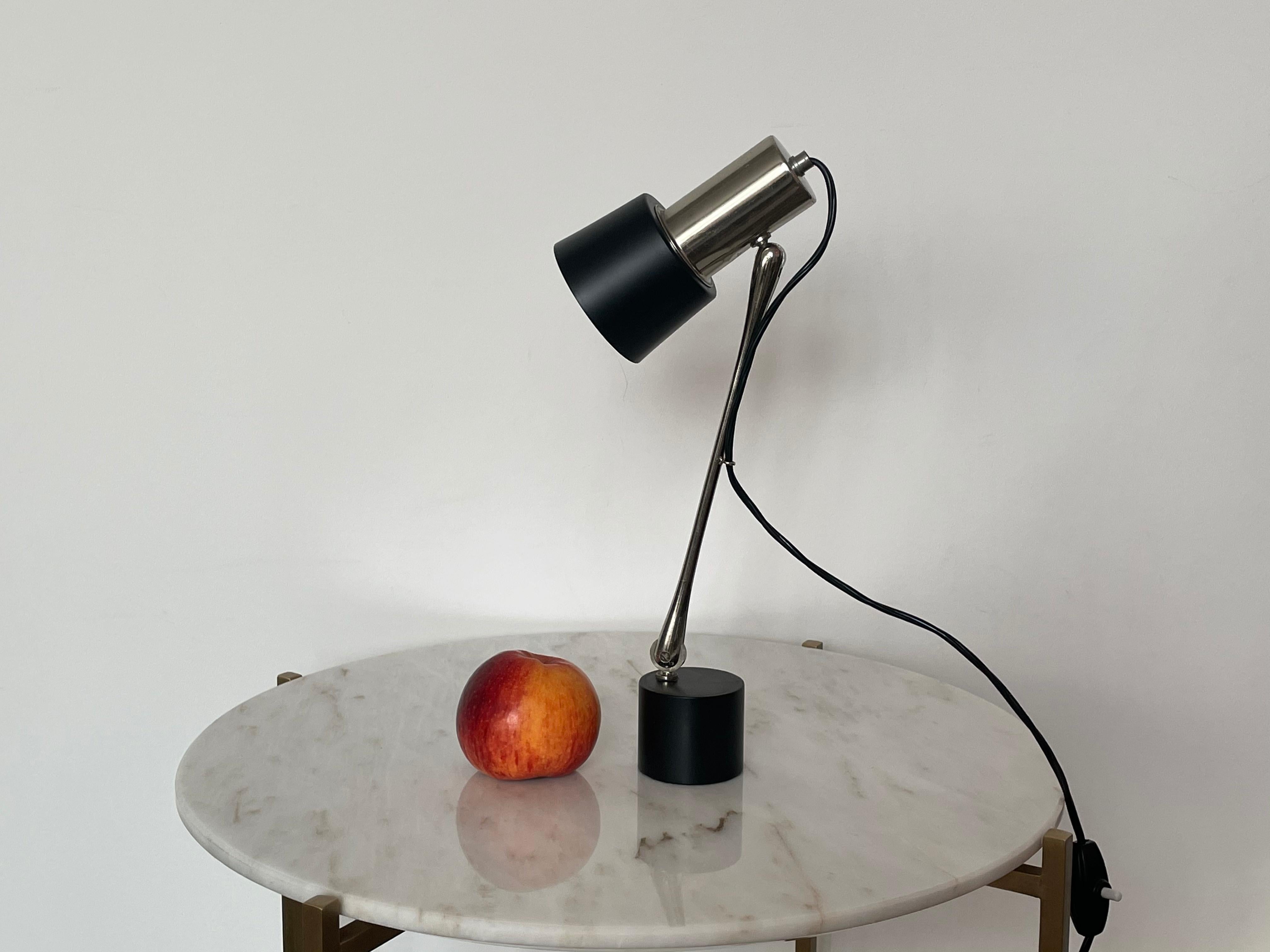 20th-century vintage table or desk lamp designed with a rotatable base and shade and made out of stainless steel and black lacquered steel.
By Italian manufacturer, Stilnovo, 1960s

------

We are an exhibition space and an online destination