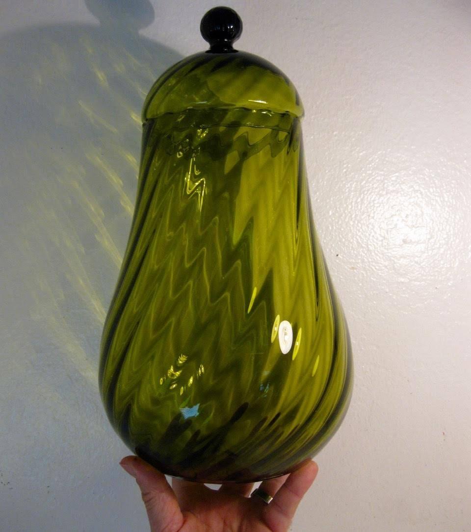 1960s Mid-Century Modern large pear-shaped, lidded apothecary jar by Empoli glass of Italy. The piece is done in an olive green color and has Empoli's iconic optic twisted strip.