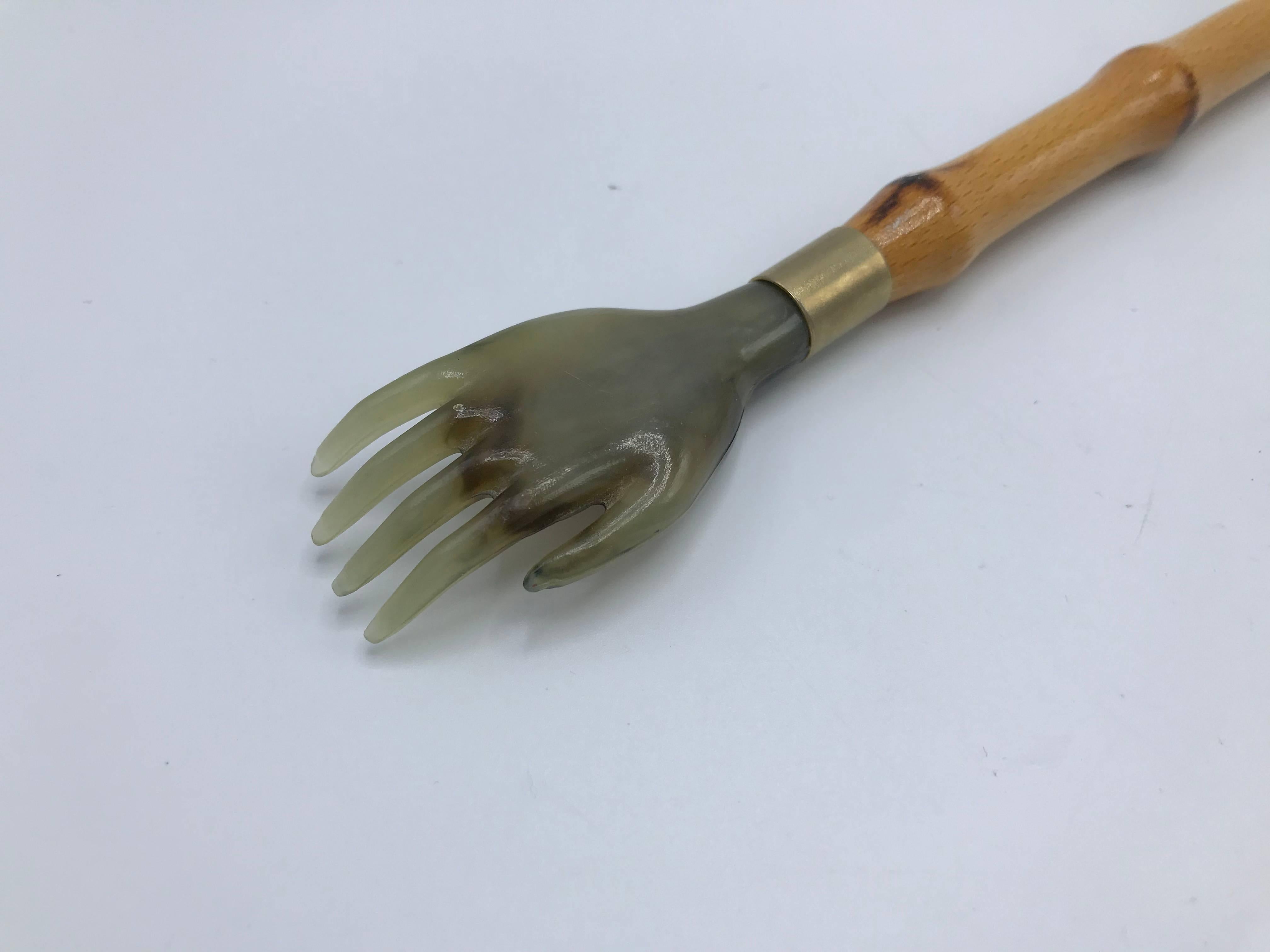 Listed is a fabulous, 1960s Italian faux-bamboo shoehorn/backscratcher. The piece has a beautiful, 'burnt' bamboo look to the wood frame. Shoehorn and backscratcher are a heavy resin with a faux-stone look. Marked with original 'Made in Italy' tag,
