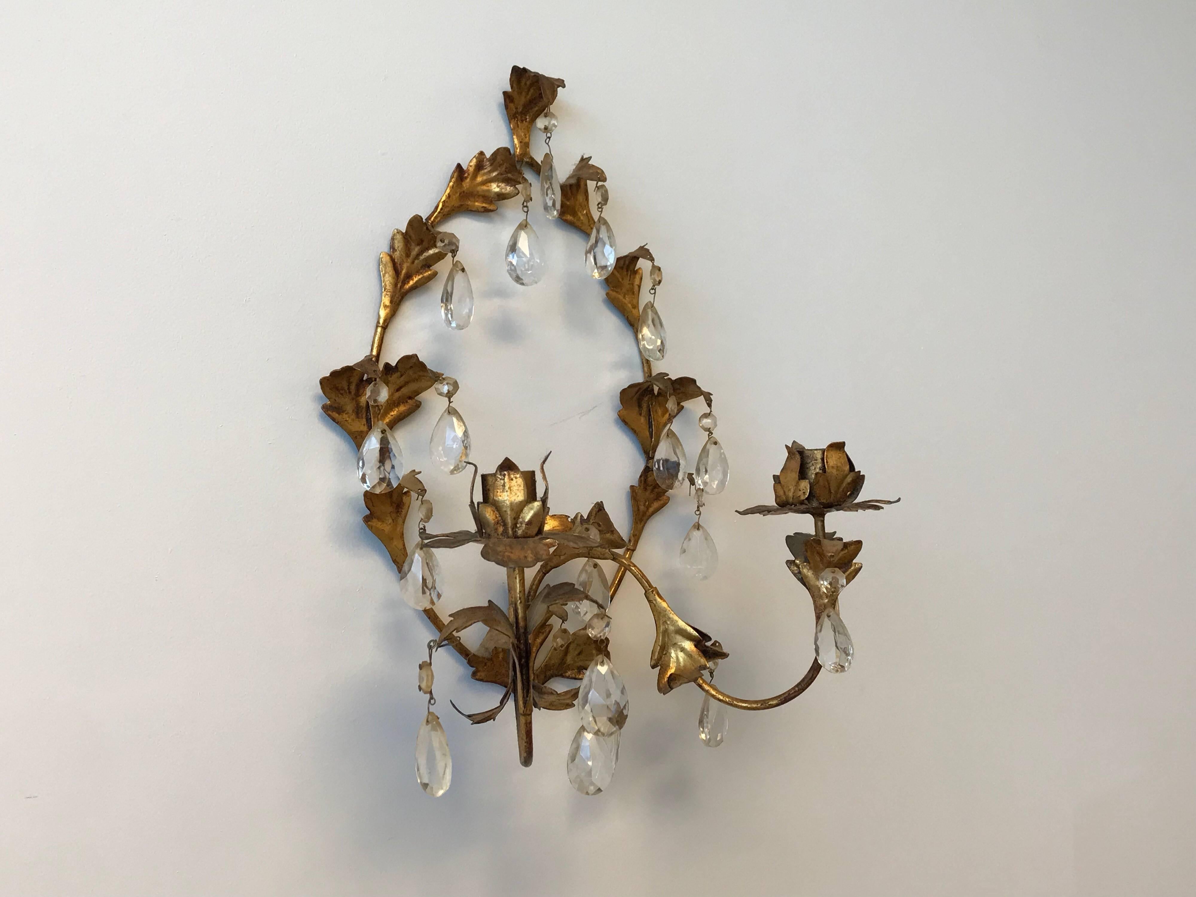 Listed is a beautiful, single, 1960s Italian Florentine gilded metal double-candlestick wall sconce. Missing some crystals, though can easily be replaced by buyer.