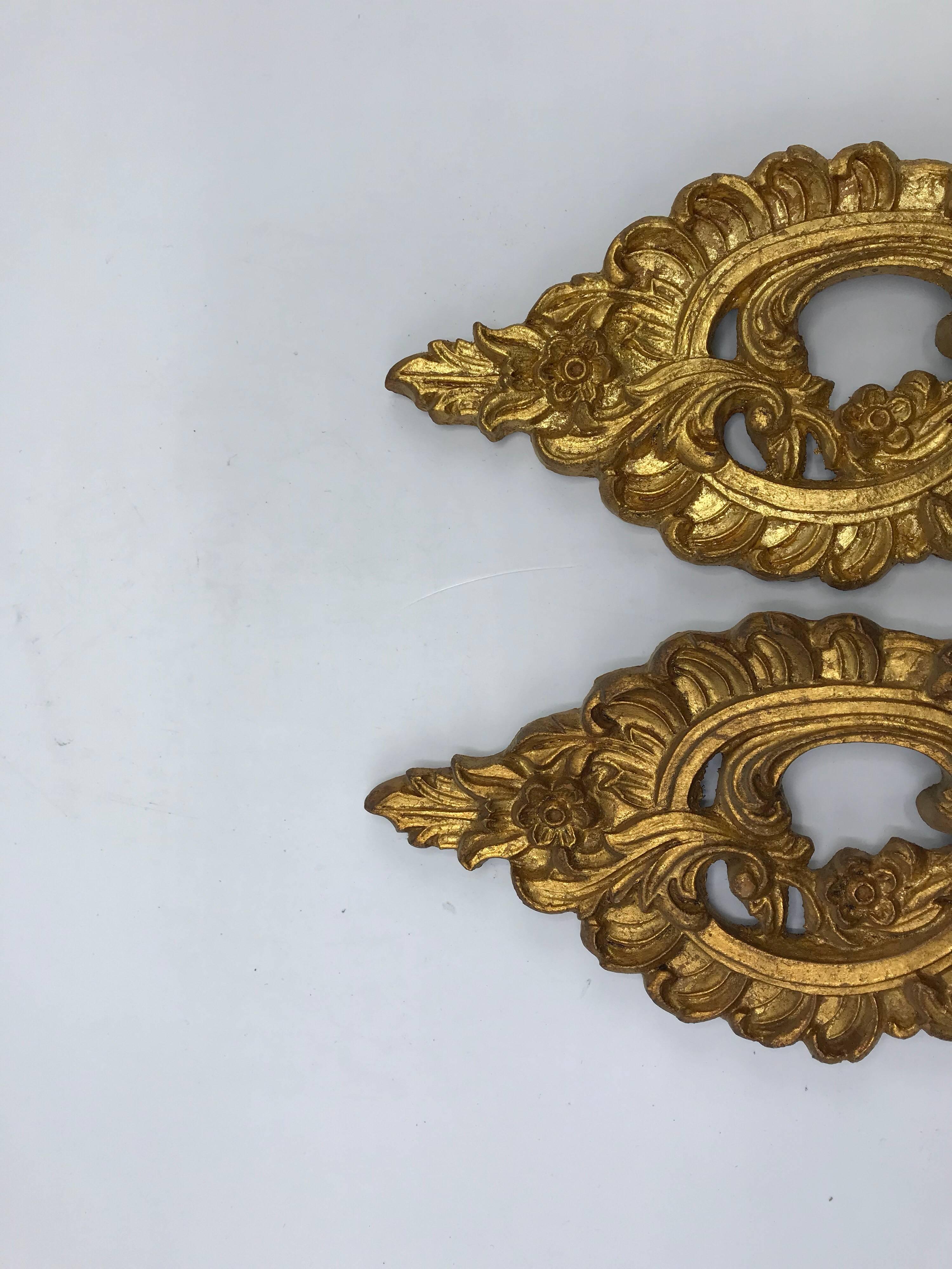 Listed is a beautiful, pair of 1960s Italian Florentine gilded candlestick wall sconces. Wood is in excellent condition. The candlestick drip plates are mismatched, but not noticeable. Can easily be replaced by buyer.