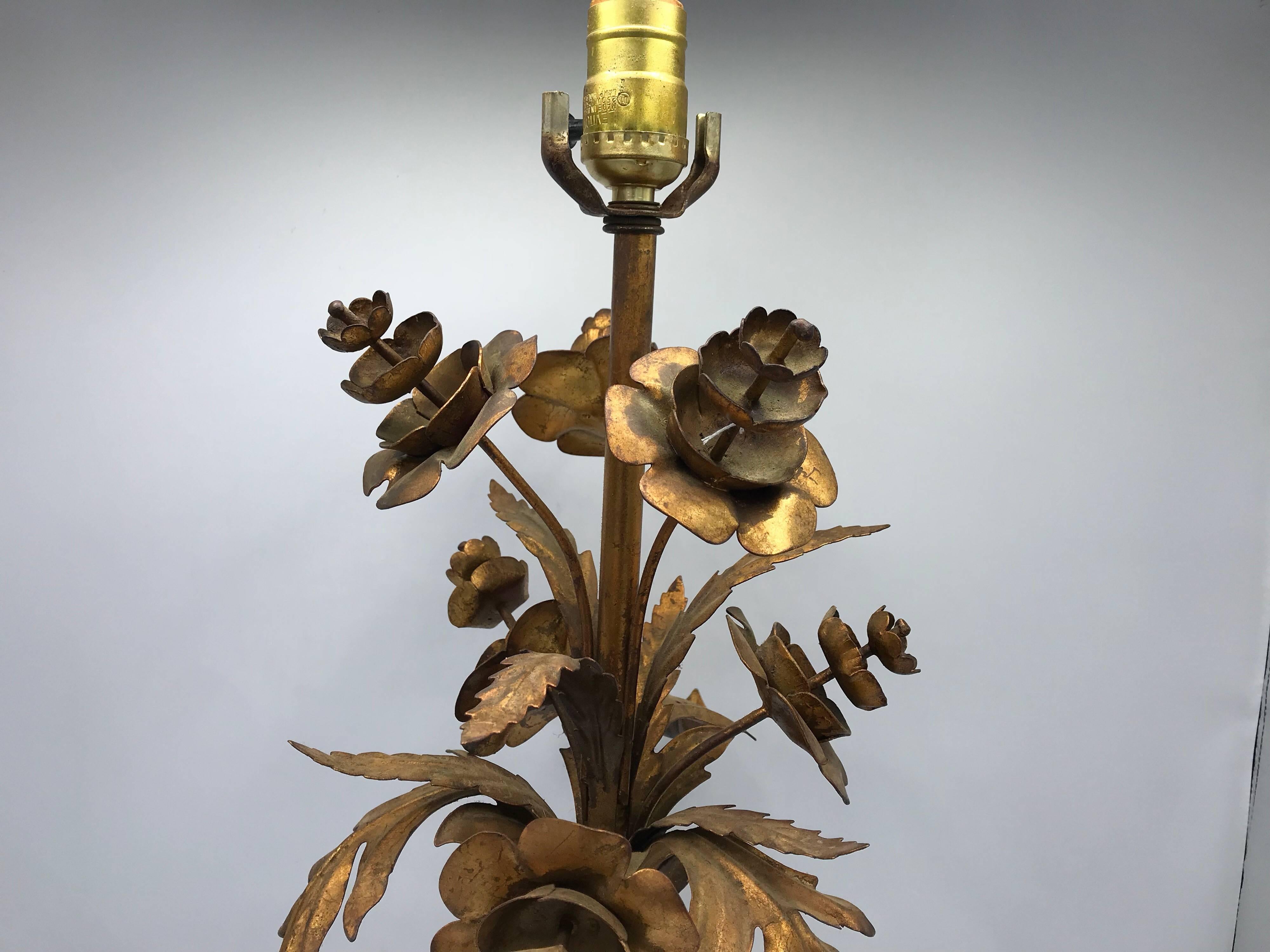 Offered is a gorgeous, 1960s Italian Florentine gilded lamp with a sculptural floral motif. Black marble base.