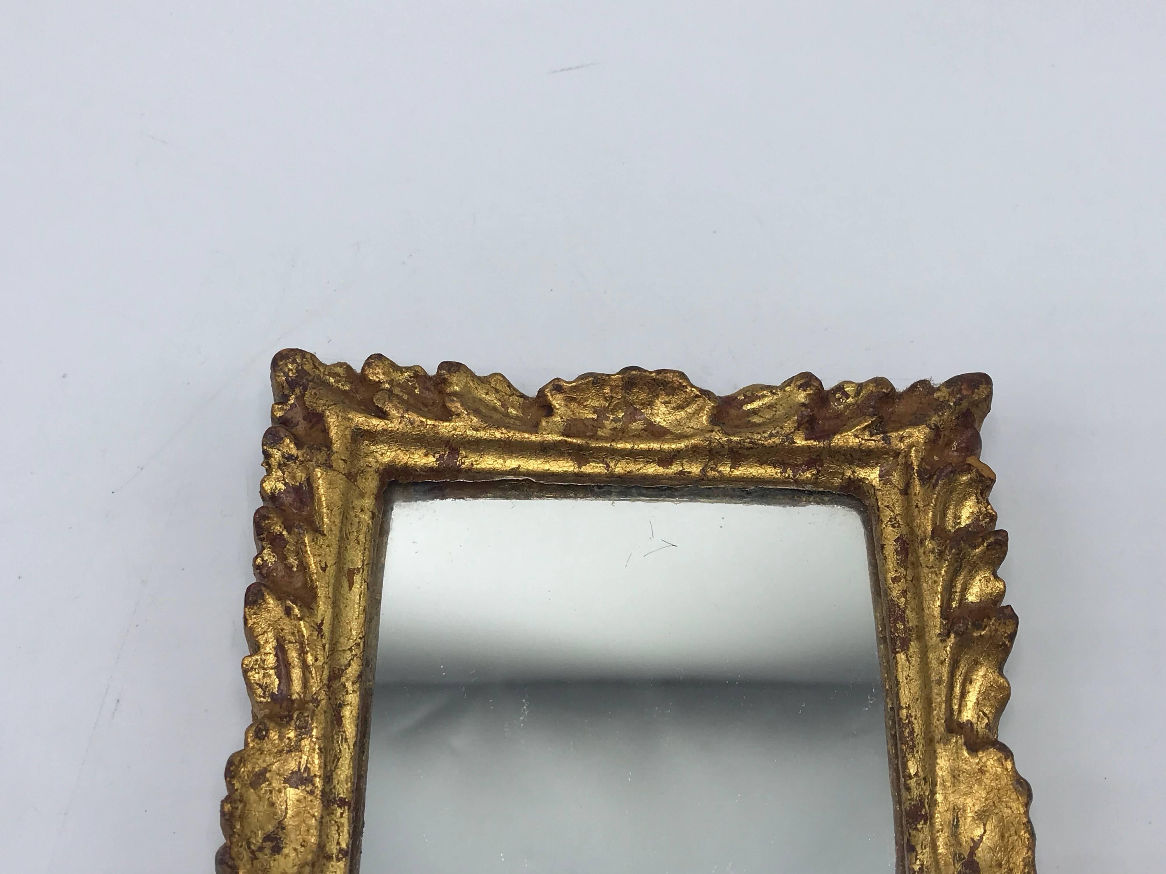 Offered is a gorgeous, small 1960s Italian Florentine gilded rectangular mirror. Marked ‘Made in Italy’ on backside.