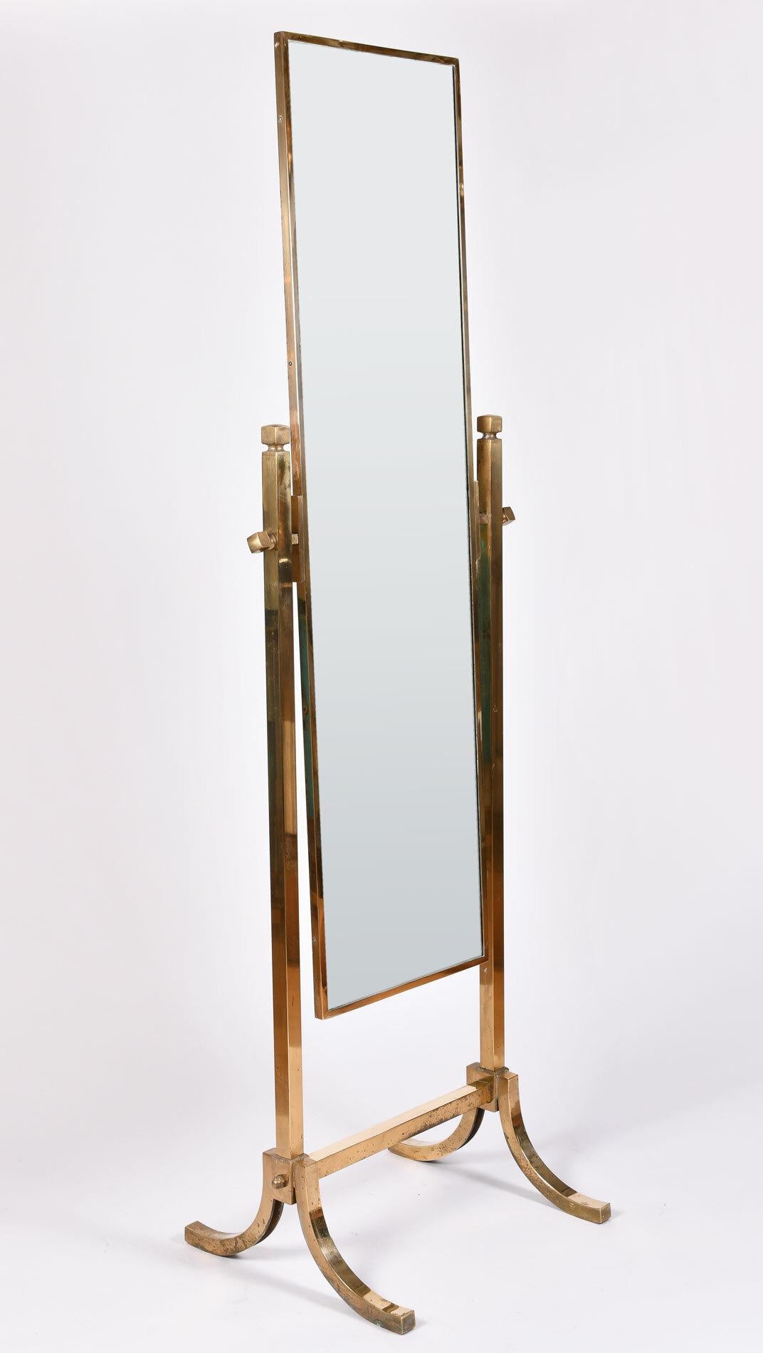 For a good look. Brass full-length adjustable mirror with rectangular frame and splayed brass legs.