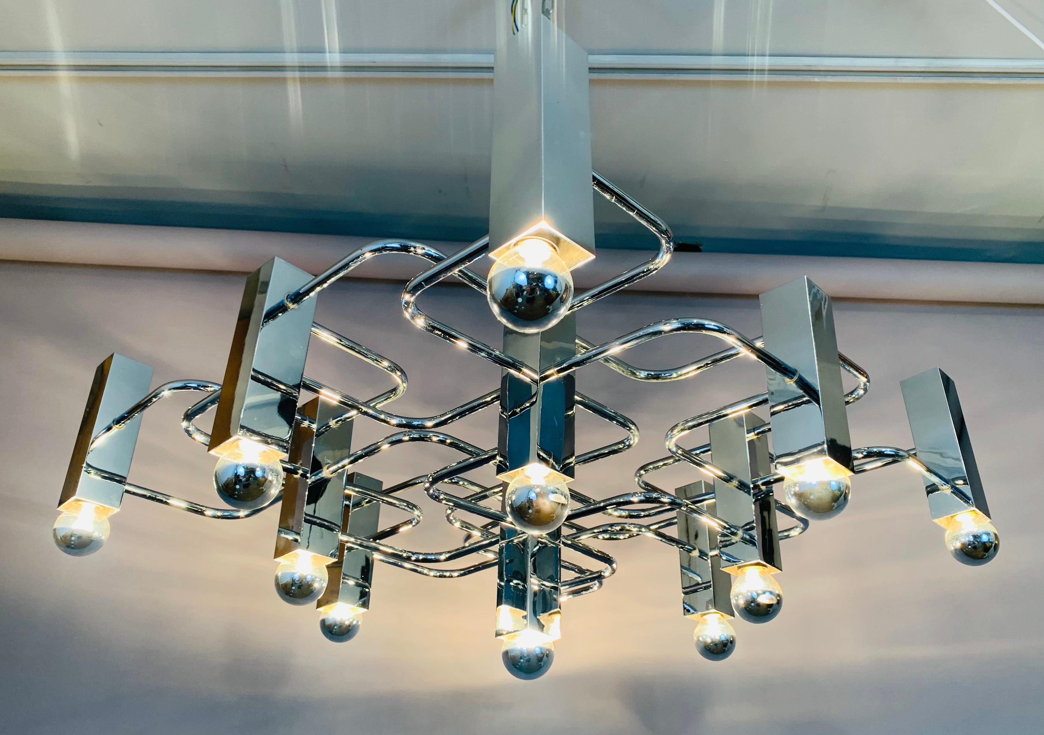 A stunning and striking chromed metal geometric chandelier designed by Gaetano Sciolari for S.A. Boulanger in Italy during the 1960s. The 13 vertical chromed square bulb holders are connected by interconnecting horizontal thin chromed tubes which