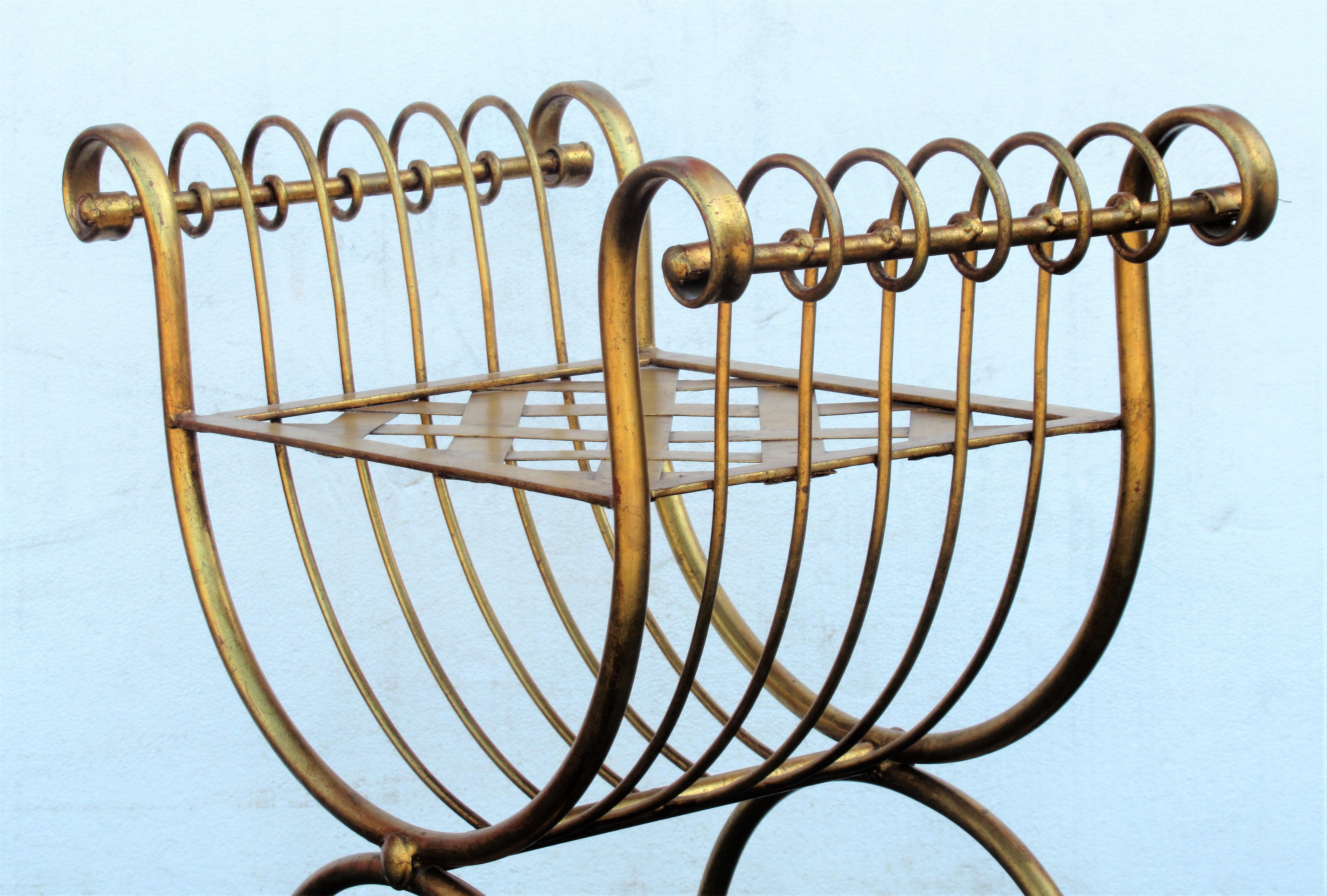 Italian gilt iron curule bench in overall beautifully aged original gilded surface with small areas of underlying red bole highlights showing, circa 1960. Look at all pictures and read condition report in comment section.