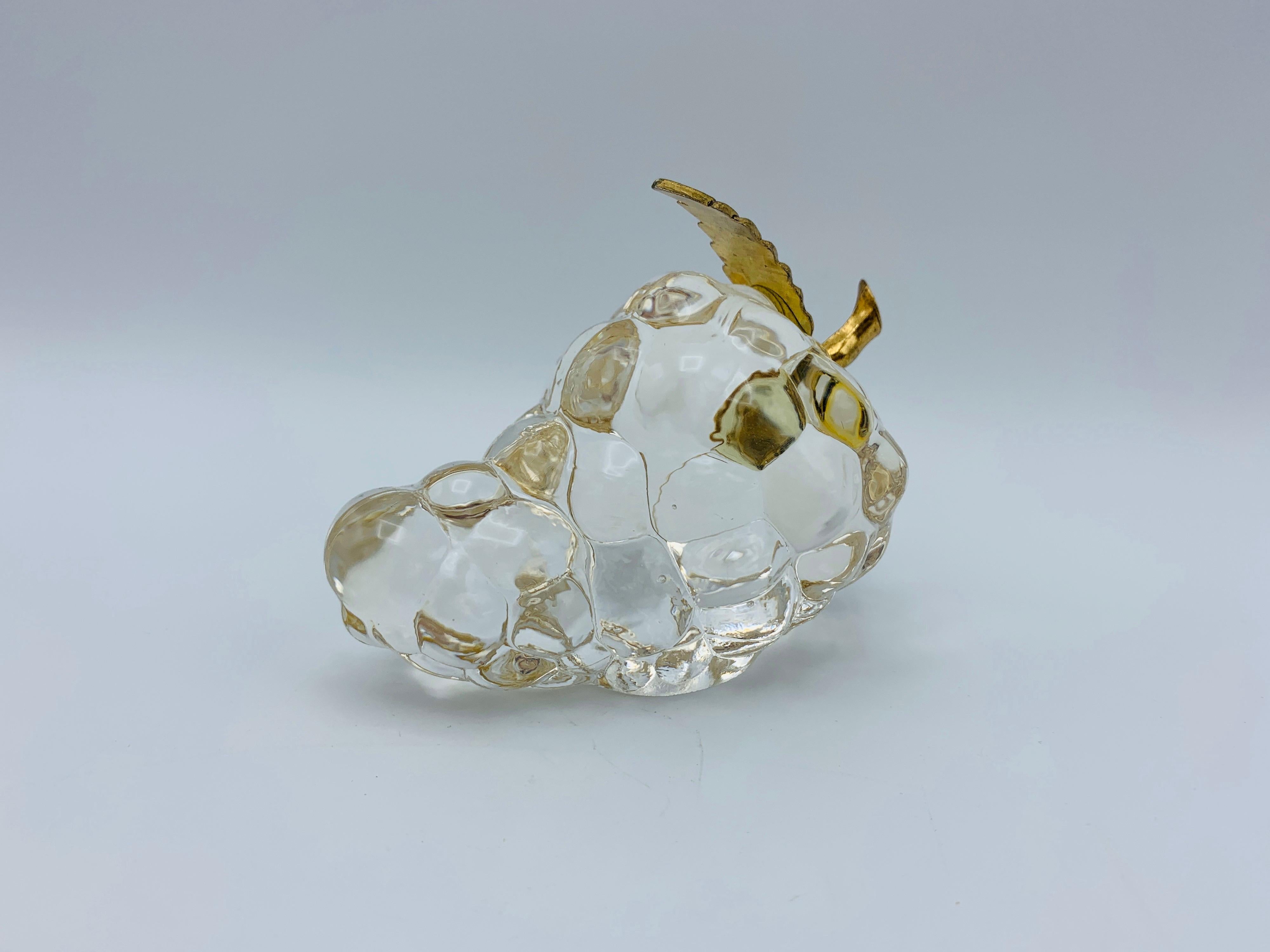 Listed is a beautiful, 1960s Italian glass grape cluster with a polished brass stem. The piece is the perfect size for a paperweight, or sculptural item on display. Heavy, weighing .7lbs.