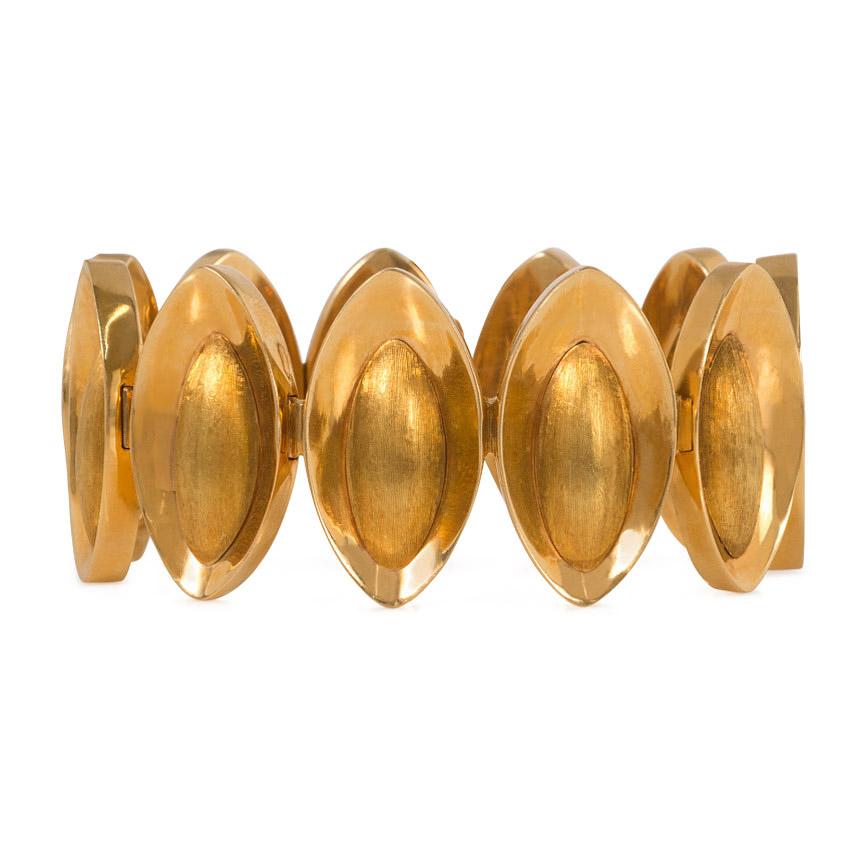 A mid-century gold bracelet comprised of concave navette-shaped links inset with oblong elements featuring a Florentine finish, in 18k.  Italy, dated 12.XII.61.  The scale of this bracelet allows it to make a statement without being overpowering,
