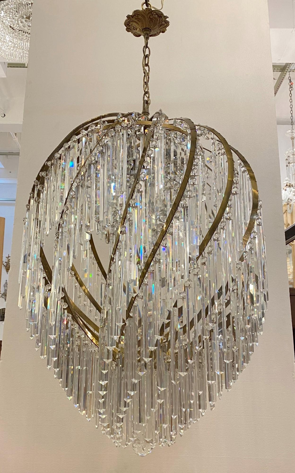 Oversized Italian made Grand Swirl style large clear crystal chandelier with a swirled brass frame. This has 17 sockets.