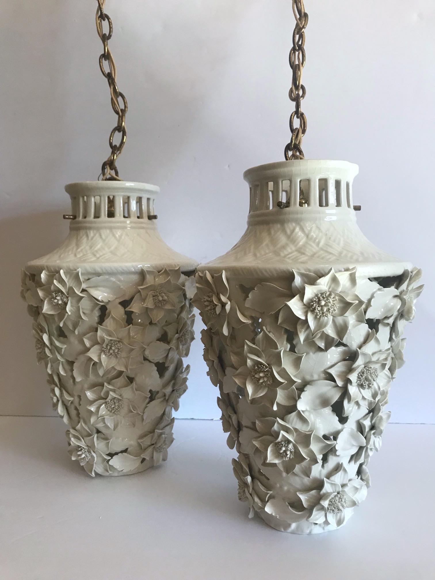 Pair of stunning Italian Blanc de Chine porcelain pendant chandeliers with exquisite floral details. The pendants have pagoda forms with etched bamboo design along the top with intricate handcrafted leaf and flowers throughout. Fitted with one light