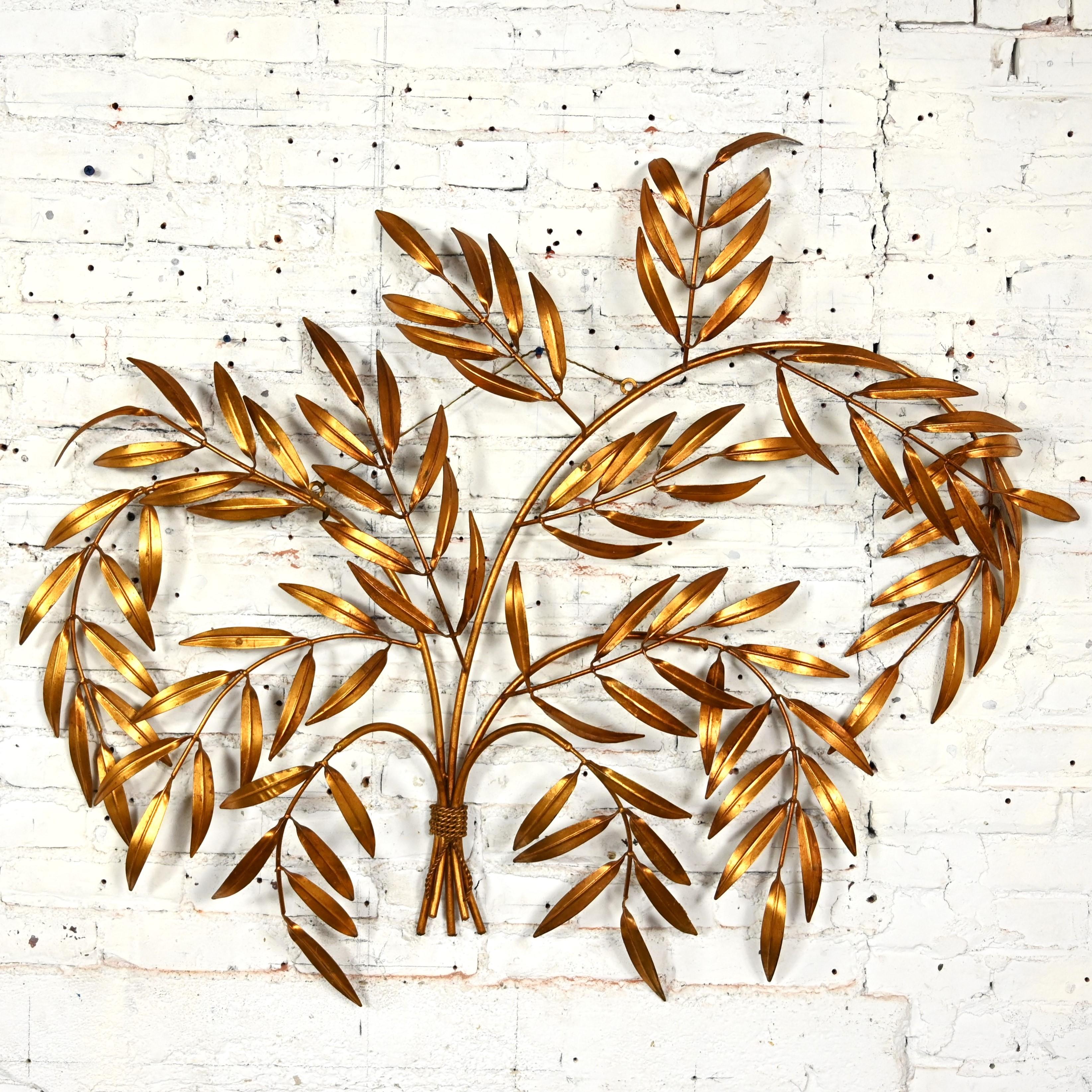 Incredible vintage Italian Mid Century Hollywood Regency gilt metal wall sculpture of branches with leaves. Beautiful condition, keeping in mind that this is vintage and not new so will have signs of use and wear even if they have been restored or