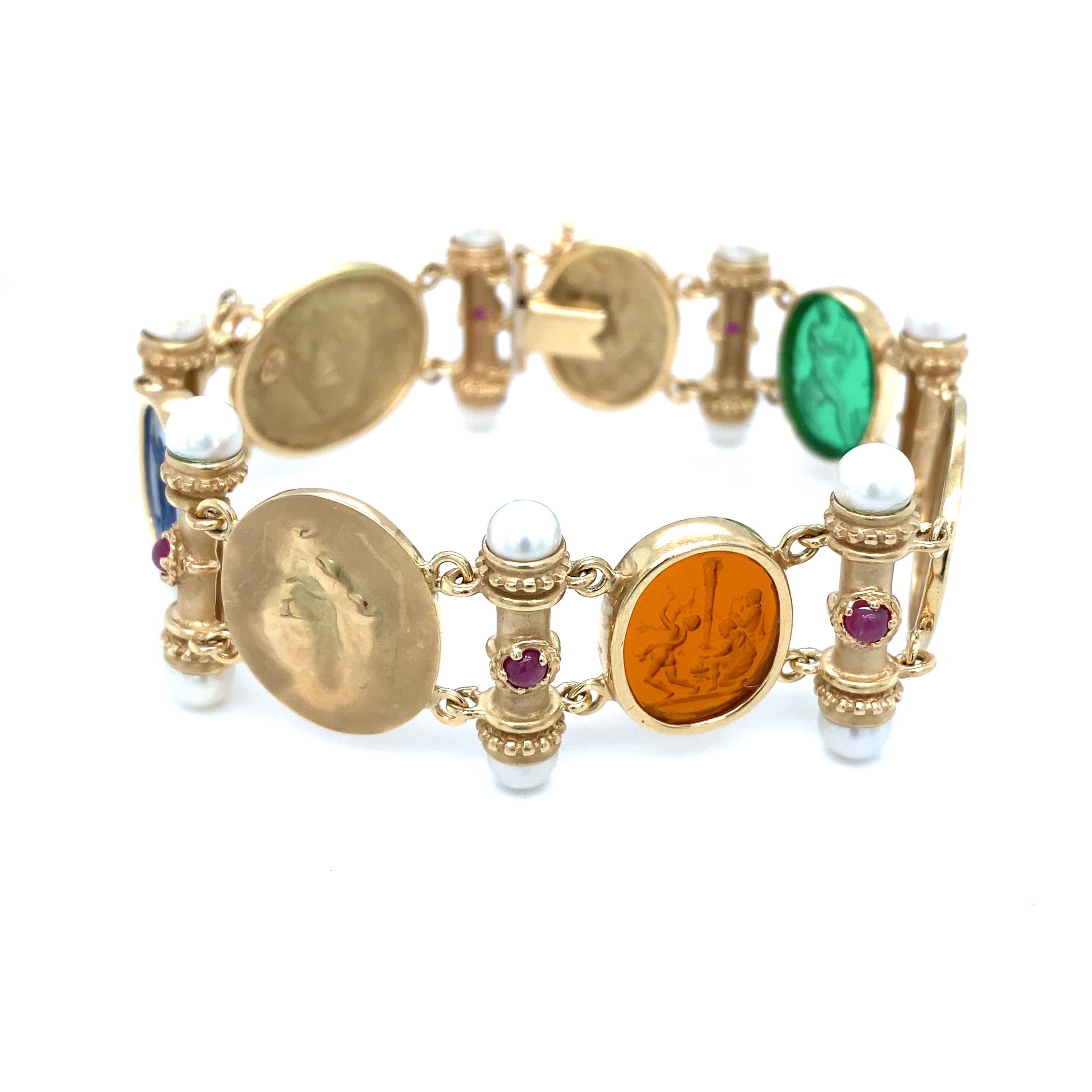 Item Details: This spectacular bracelet is a gorgeous piece from Italy. Complete with glass intaglios, pearls, and rubies, this bracelet is a beautiful statement piece. The intaglios feature scenes from Roman mythology, and the oval links between