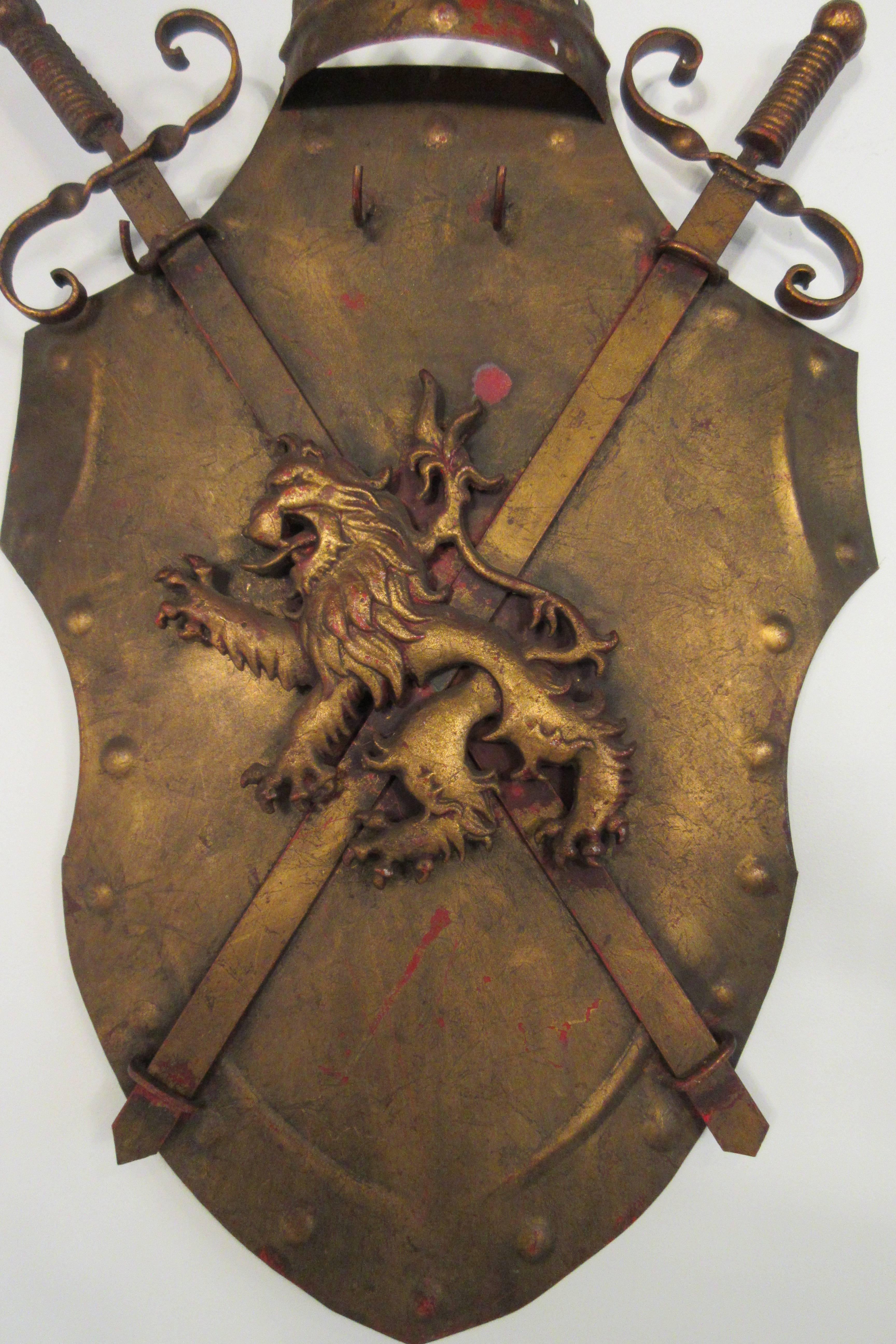 1960s Italian iron shield has three hooks and two swords.