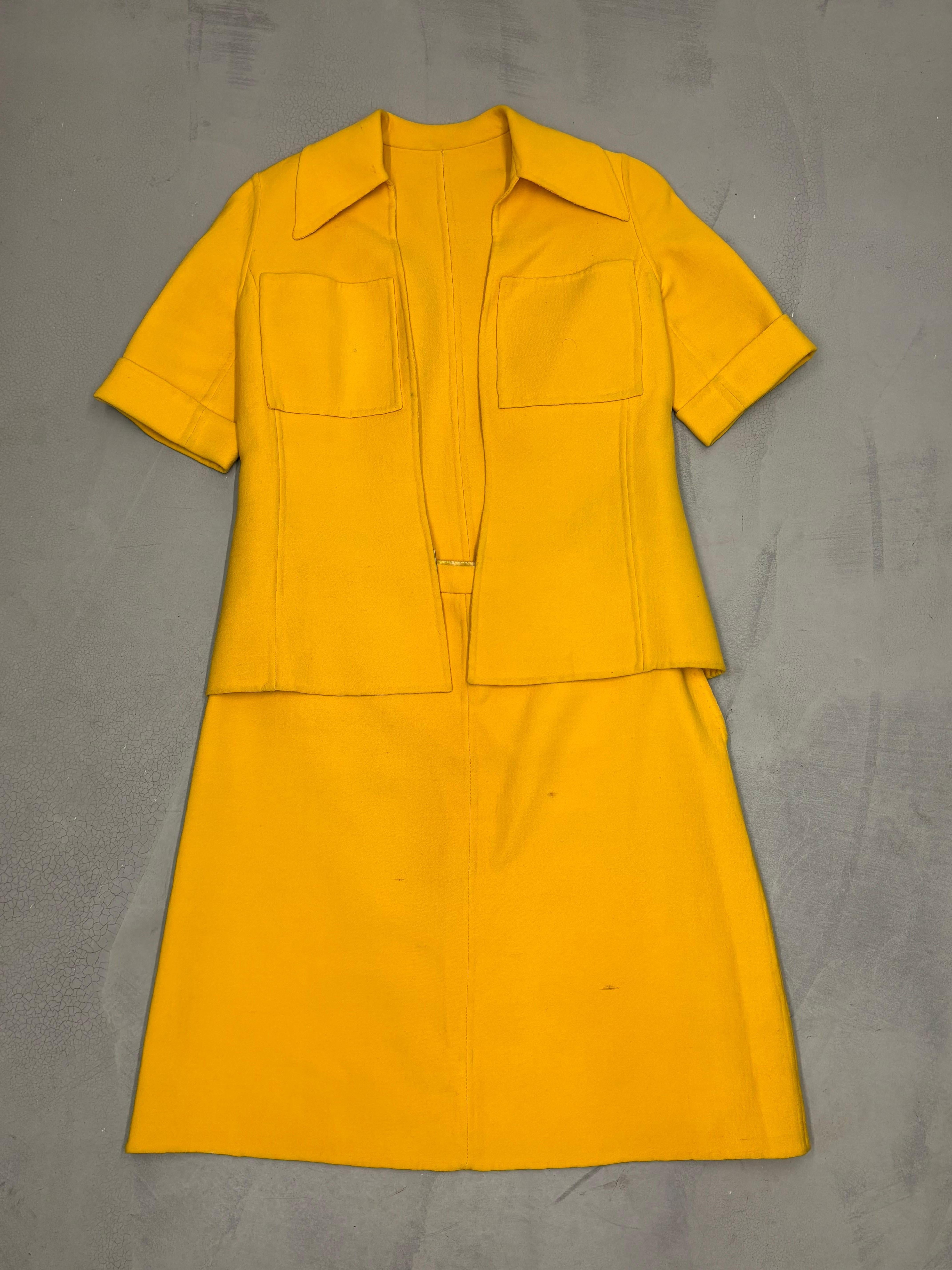 Italienische vintage maßgeschneiderte Jacke und Rock Set aus den 1960er Jahren

Gelbe Jacke mit zwei Taschen und Reißverschluss 
Breiter Kragen
Gelber Rock mit seitlichem Reißverschluss 
Größenetikett fehlt, passt für M

Jacke - Gesamtlänge: 53 cm -