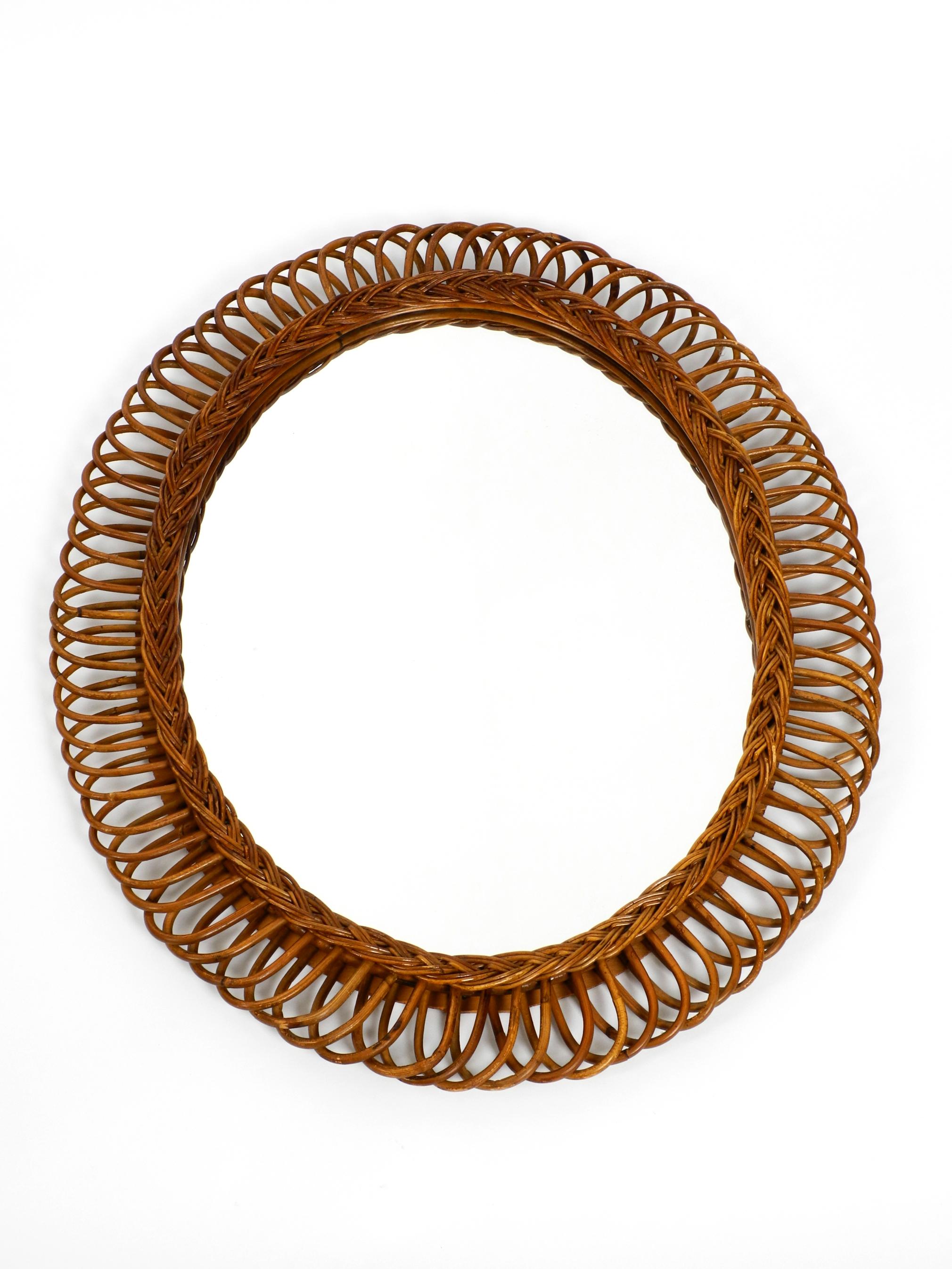 Beautiful rare large Italian bamboo rattan wall mirror from the early 1960s.
Frame and the loops are made of curved dark brown bamboo or rattan.
Abstract Minimalist design. Mirror is without damages.
No scratches or chipping. Not dull.
Frame has