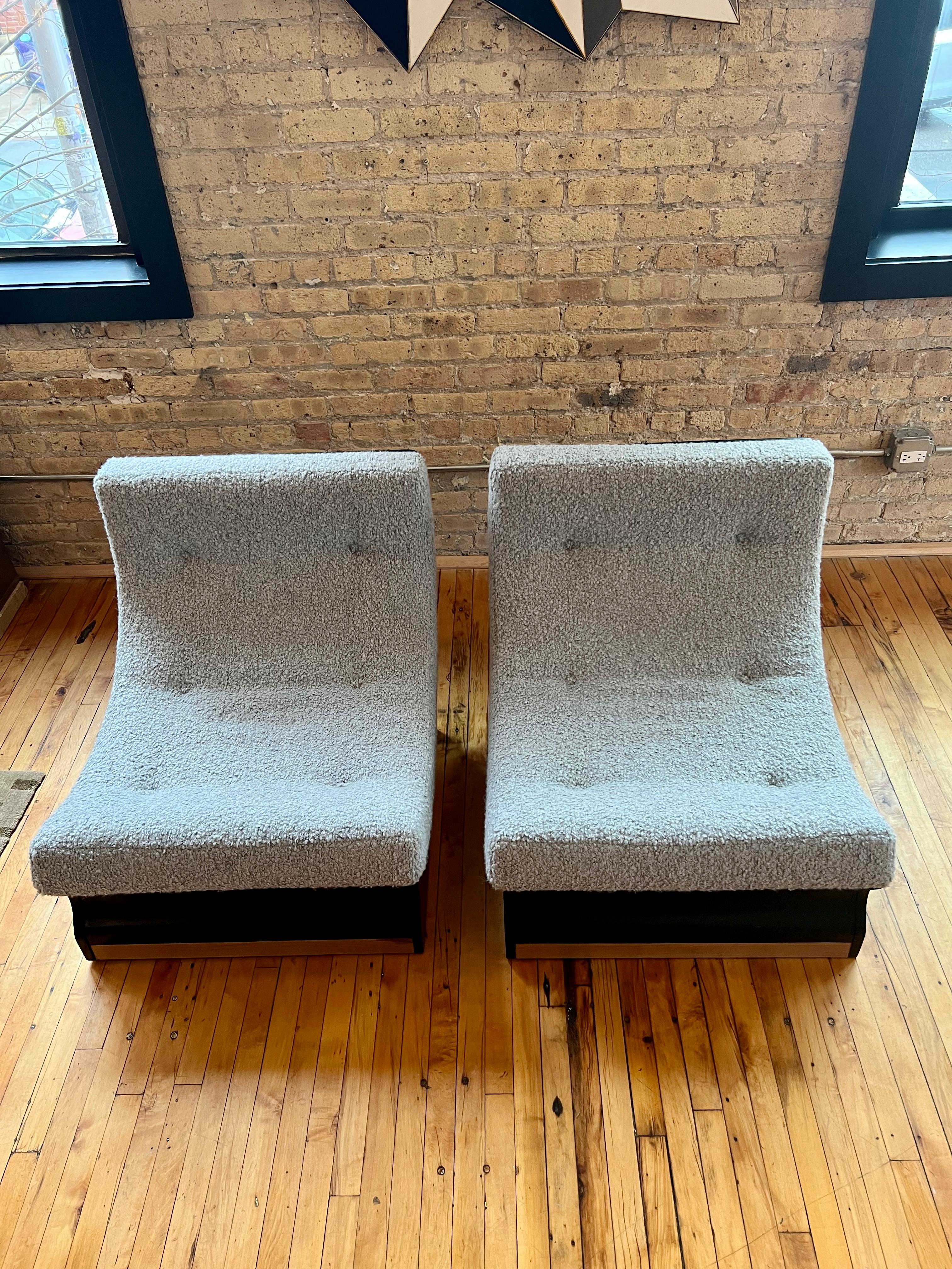 Low Italian lounge chairs, circa 1960 sold as pair. Featuring hand lacquered curved wood backs and muscular plinth bases. Newly reupholstered in Holly Hunt Teddy/ Warm Silver - Wool, Alpaca. These chairs are modern and comfortable for any space.