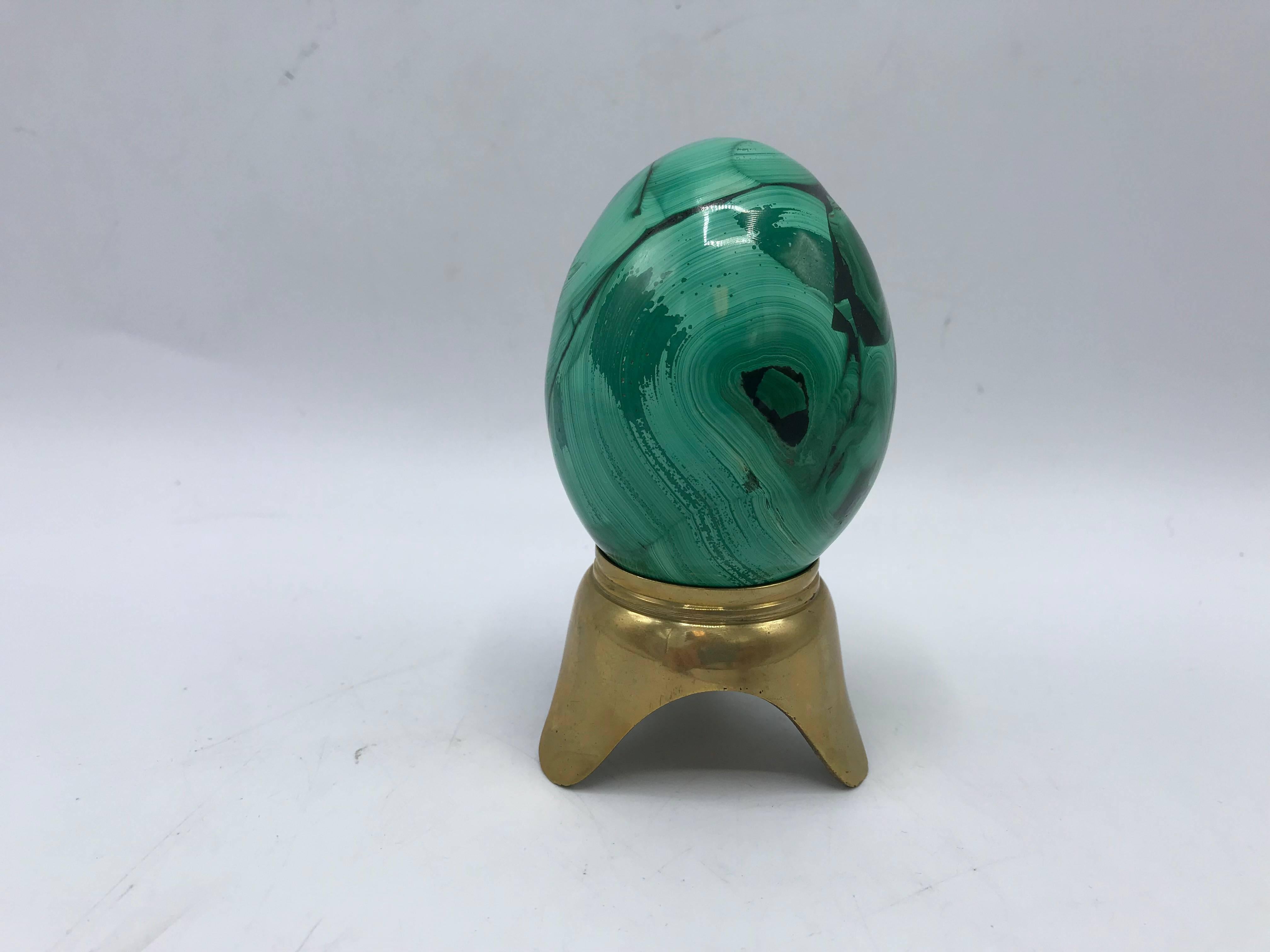 Listed is a stunning, mod and glam, 1960s Italian solid-malachite egg sculpture on a solid-brass Stand. The piece is beautiful and heavy for its small size.