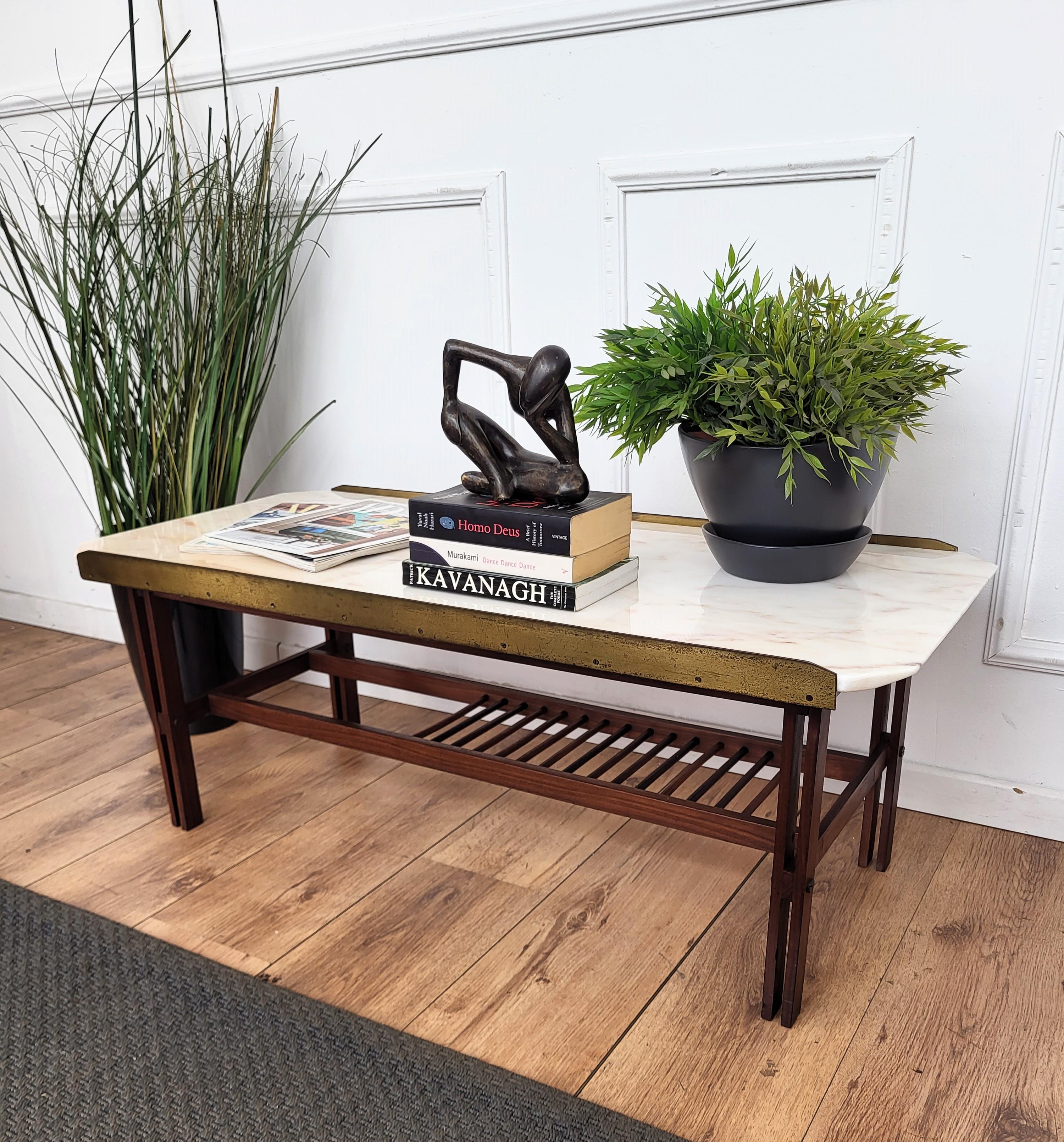 Beautiful and stylish vintage 1960s Italian brass marble and wood side table or coffee table or sofa table. Very good condition with great brass side frame for the beautifuly saped marble top on a detailed carved wood structure. A great piece that