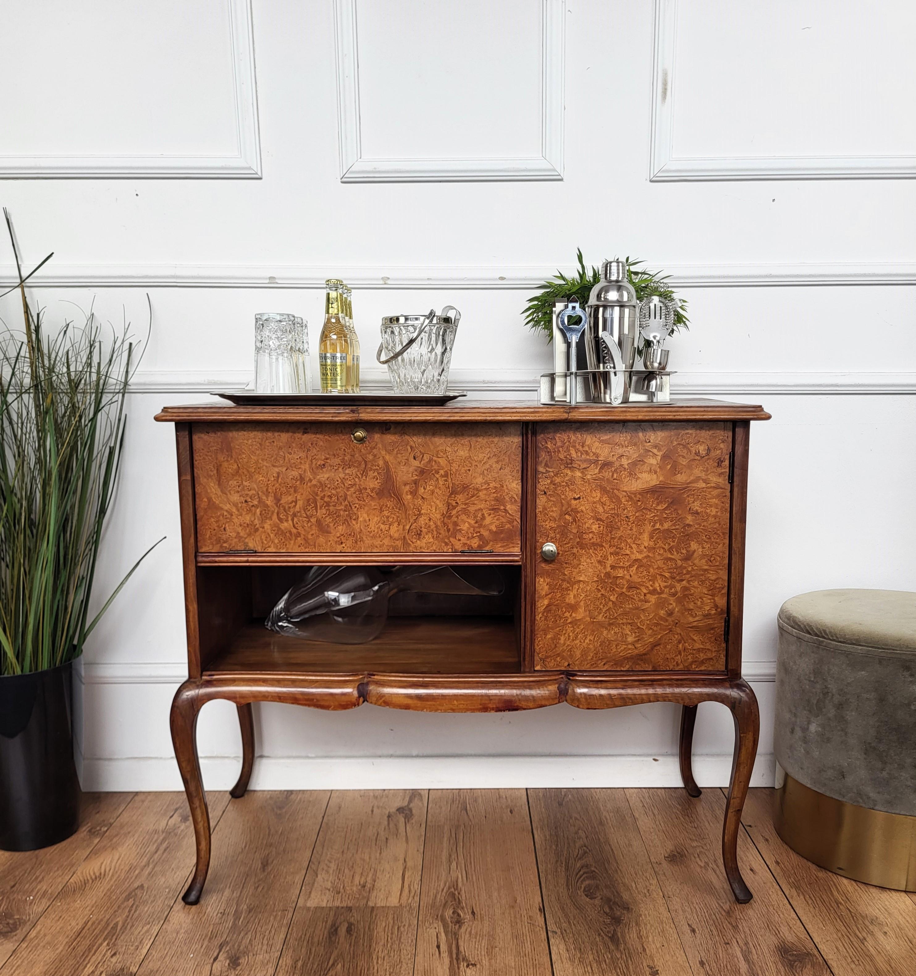 Beautiful and very elegantly shaped Italian Mid-Century Modern dry bar cabinet, with beveled framed top and brass handles. On the right a nice storage space with a door while on the left a flipping door opens to a shelf that probaby used to be meant
