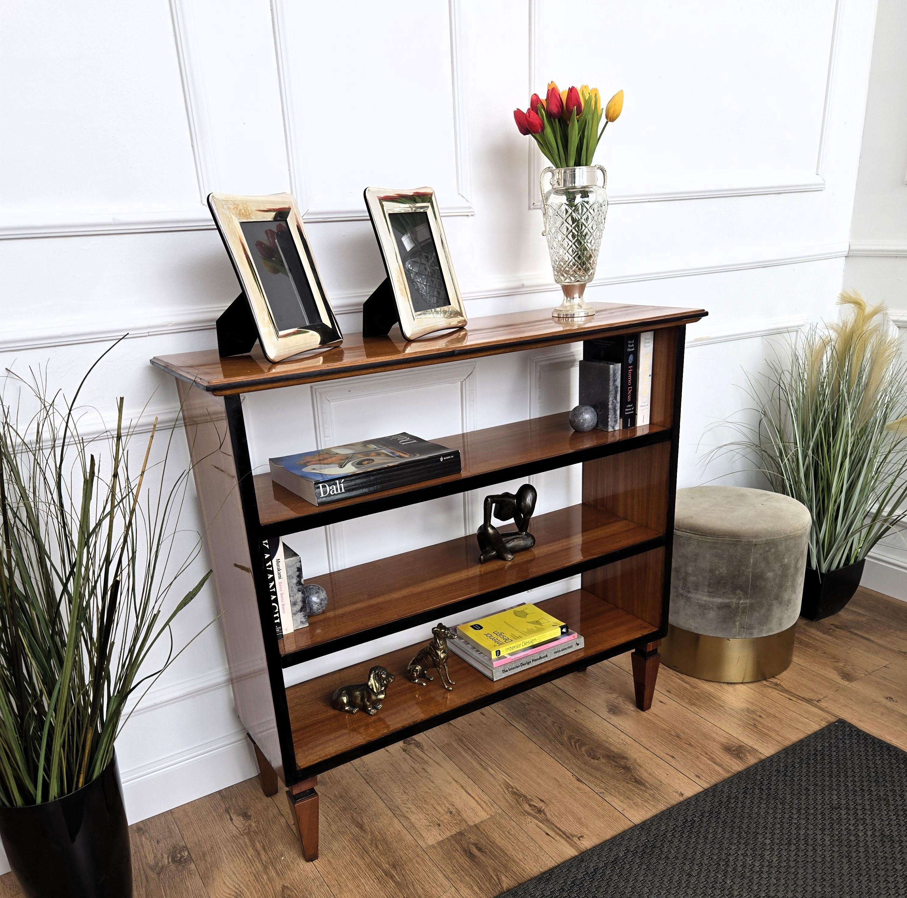 A beautiful Italian walnut, frame carved, three shelves, open bookcase, with great details and frames shaped in typical Mid-Century style with beautiful wood veneer veins color and decor.
