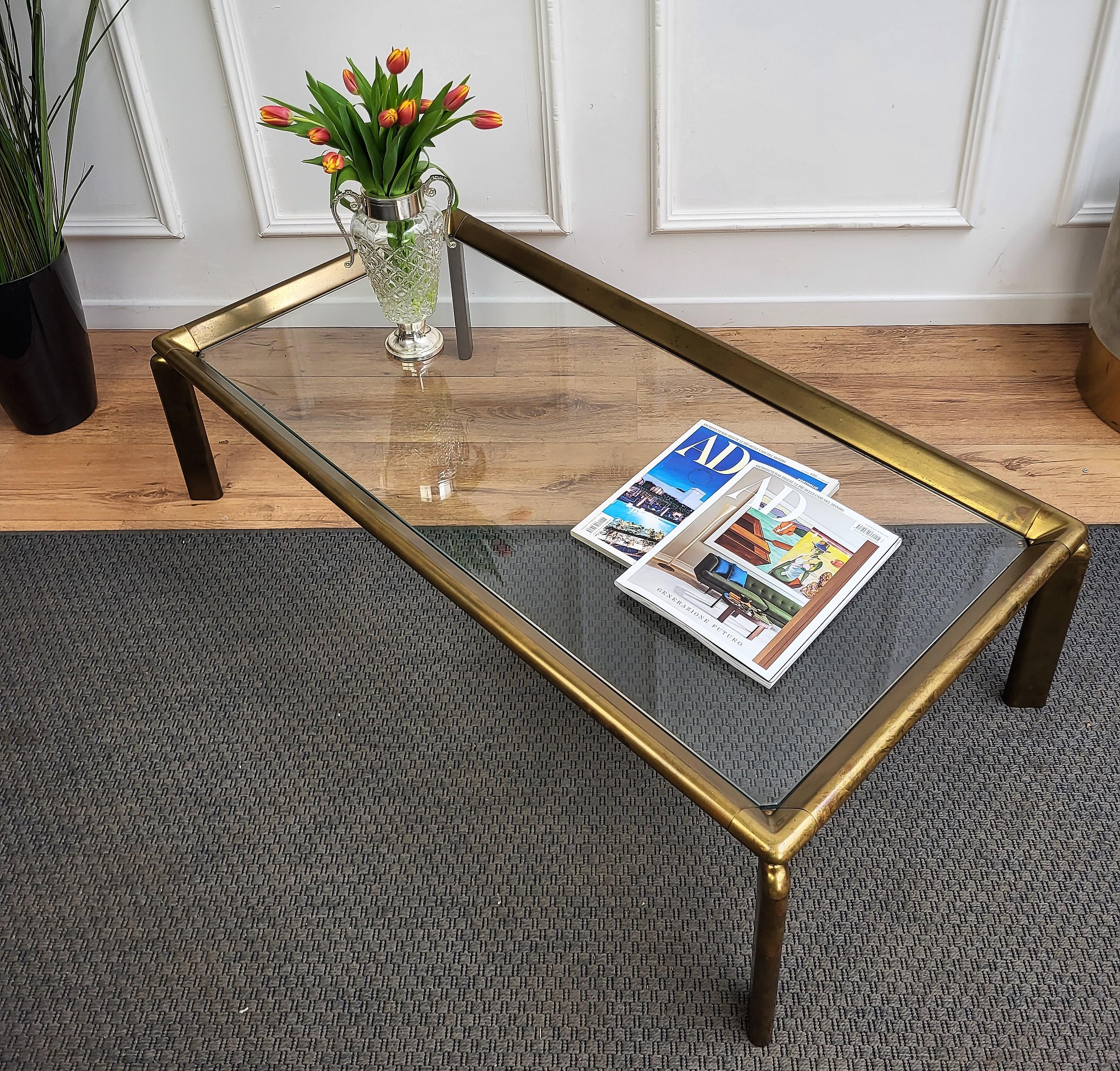 Beautiful and stylish vintage 1980s Italian brass and glass side table or coffee table or sofa table. Very good condition with great brass and glasses. A great piece that perfectly adds to every home decor the typical glitz, glamour and gold of
