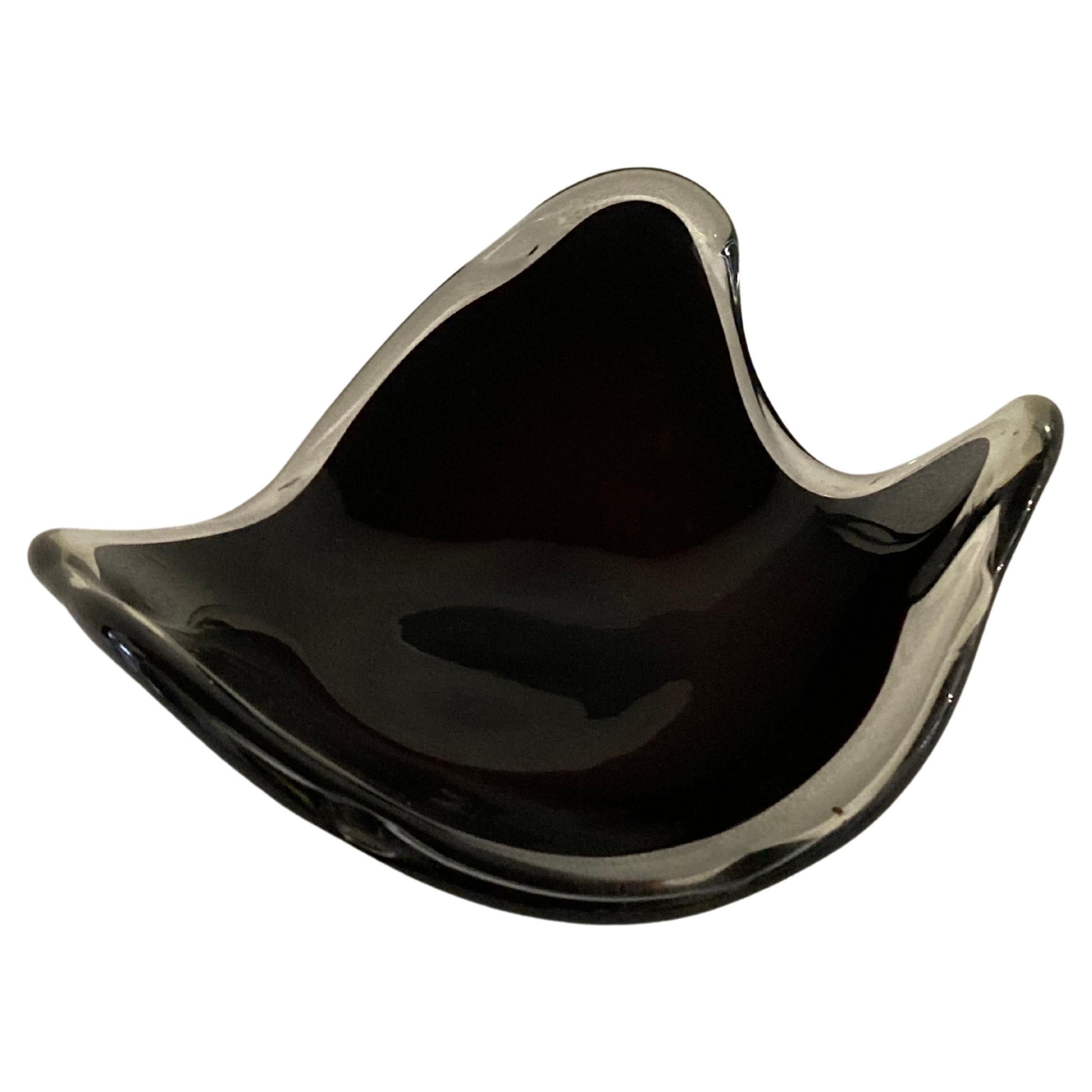 A 1960s Italian Murano dark purple clear case centrepiece dish in the shape reminiscent of a manta ray.

The island of Murano in Venice, Italy is renowned for its very long tradition of glass-making, which begun in 1291.
By the 20th century,
