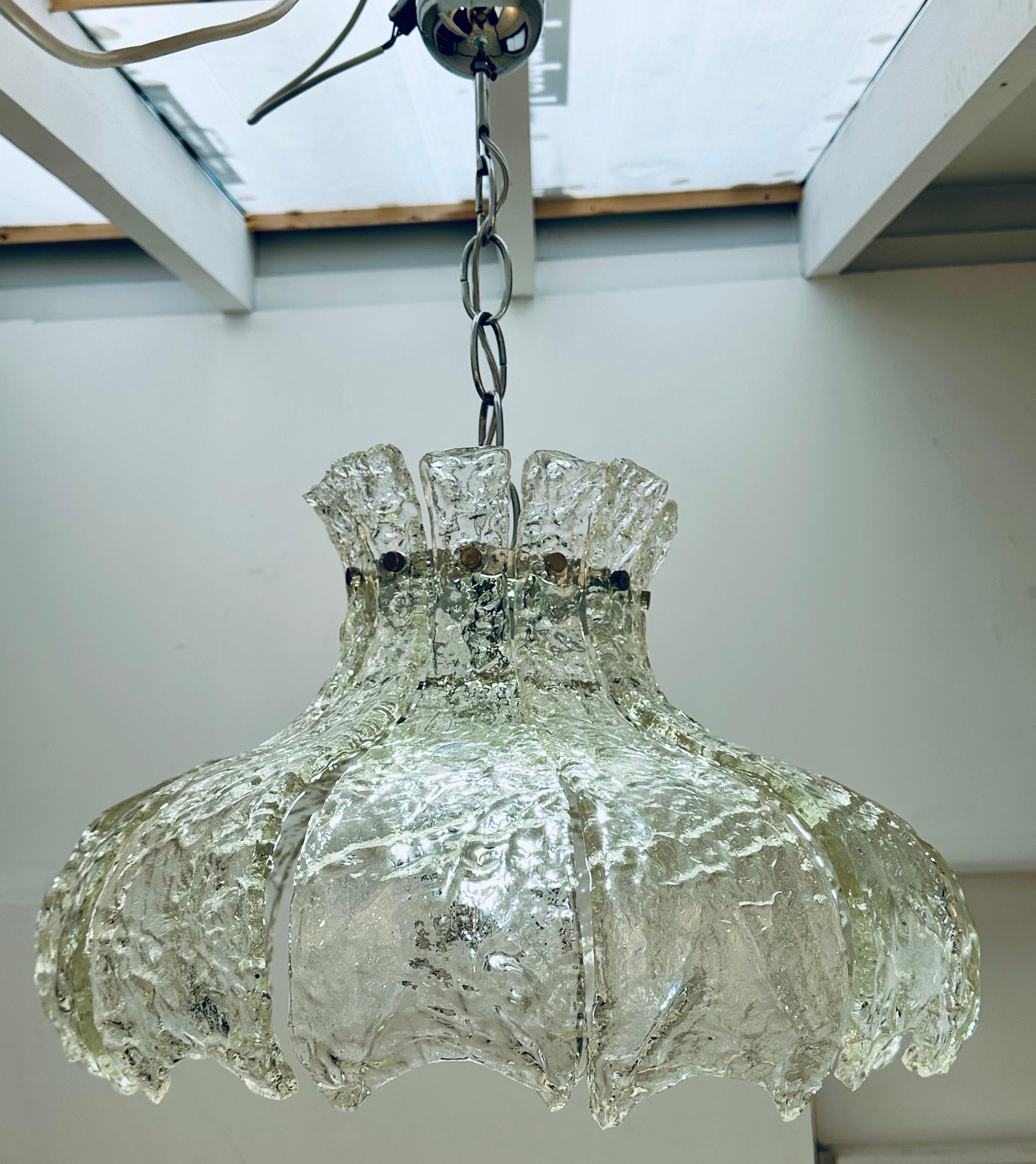 1960s Mid century Italian Murano glass pendant light with 12 individual curved textured thick clear-glass forked petals which are secured with a small chrome flat-head screw onto a chromed-metal frame to form a large hanging tulip flower. As you can