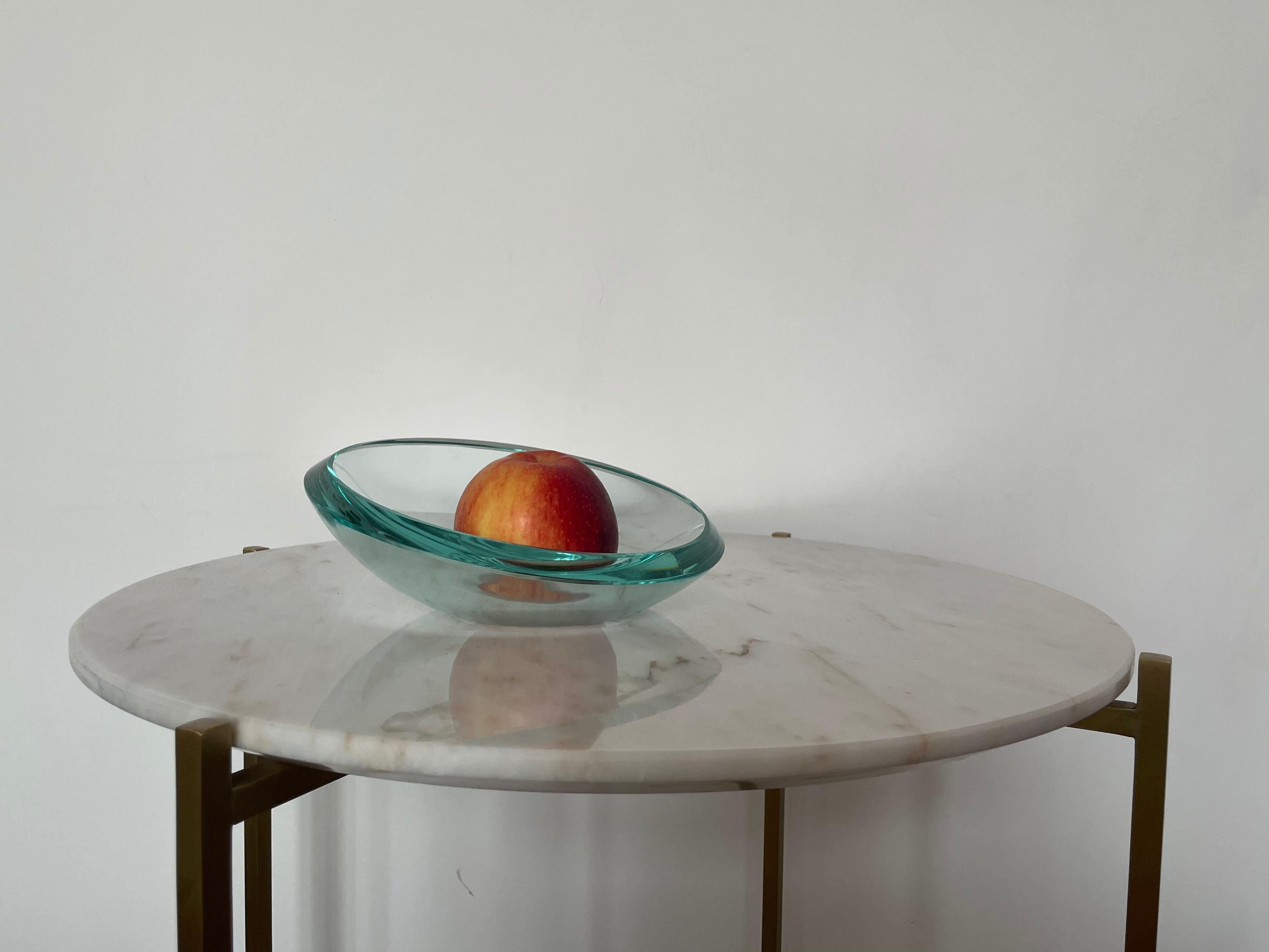 A 20th-century collectible vintage centerpiece, decorative bowl, or dish designed by the notable Italian brand that still manufactures and collaborates with grand designers to this day. This elegantly curved bowl crafted with quality art glass