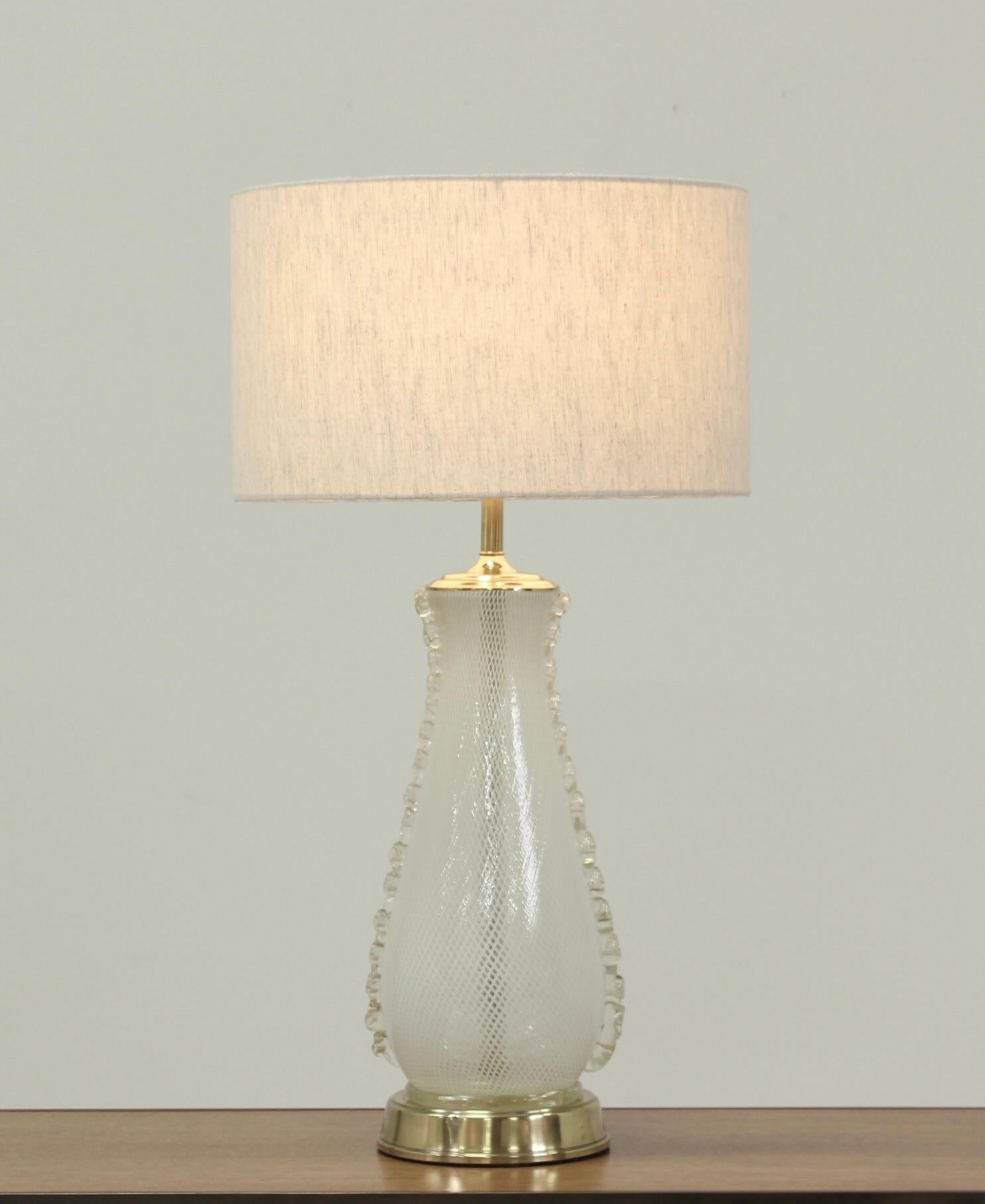 1960s Venetian “latticino” glass lamp with applied clear glass decorative handles by Camer Glass, Italy . This elegant lamp has been newly wired, it’s original brass hardware has been cleaned and polished. The lamp has been paired with one of our