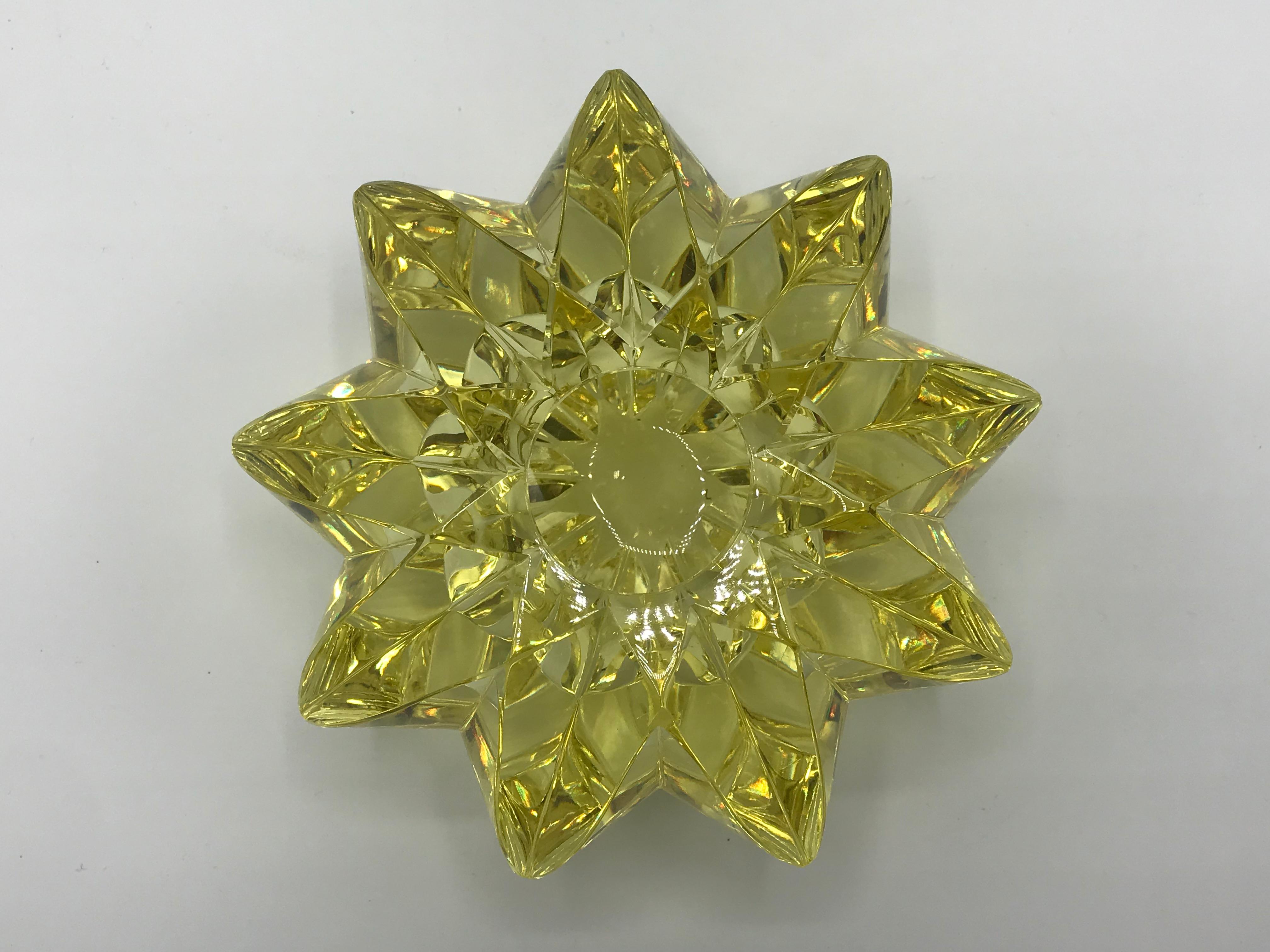 Offered is a stunning, 1960s Italian yellow Murano glass vase. The piece is shaped in a three-dimensional starburst, with a hallowed center to hold water. Signed on underside, though illegible. Heavy, weighs 4.5lbs.