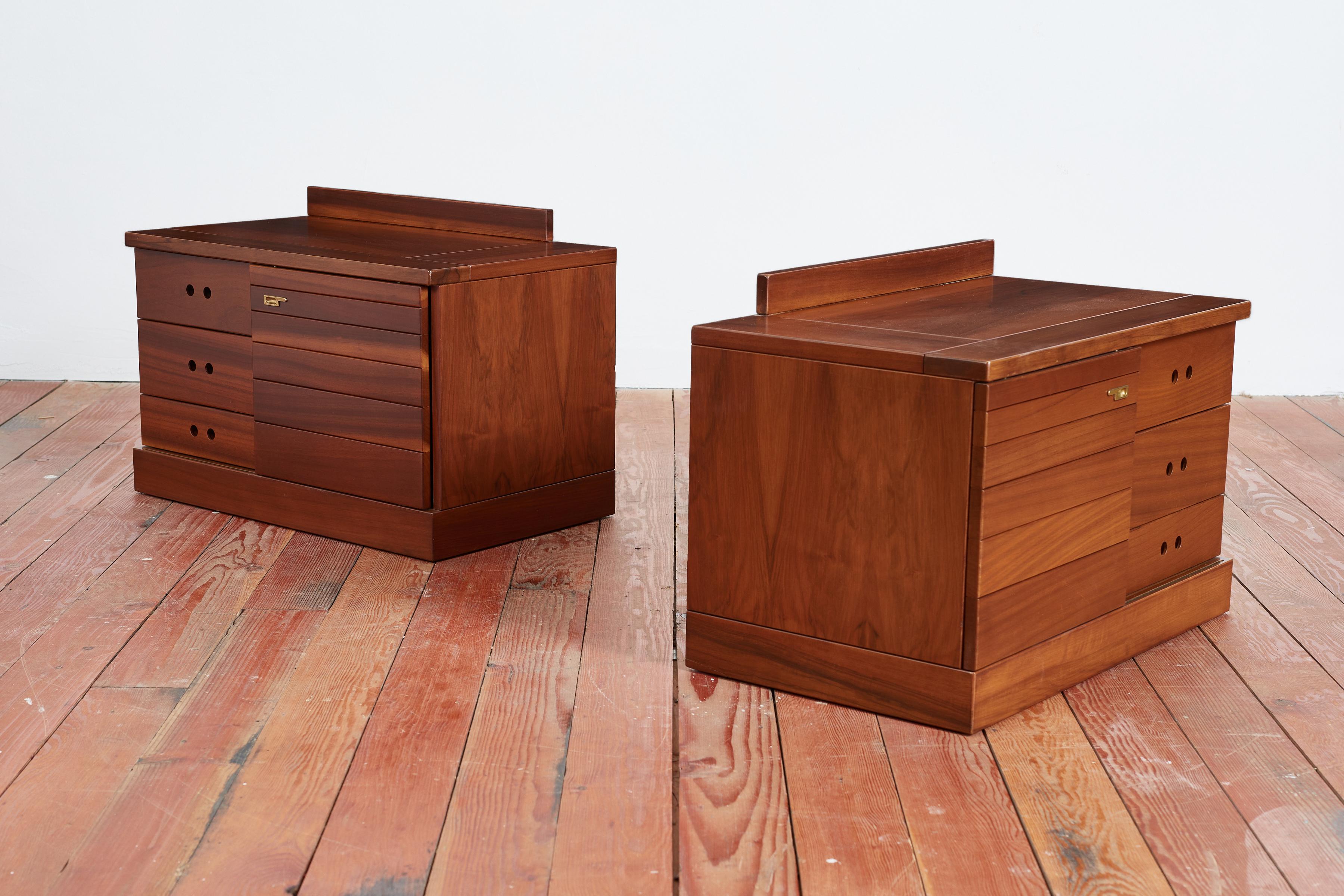 Handsome pair of Italian nightstands  - Italy, 1960's 
Beautifully constructed of Cherry Wood with 3 drawers on one side and a sliding door to reveal hidden shelving on the other. 
Brass hardware 
Newly Refinished 
Functional and great design! 
