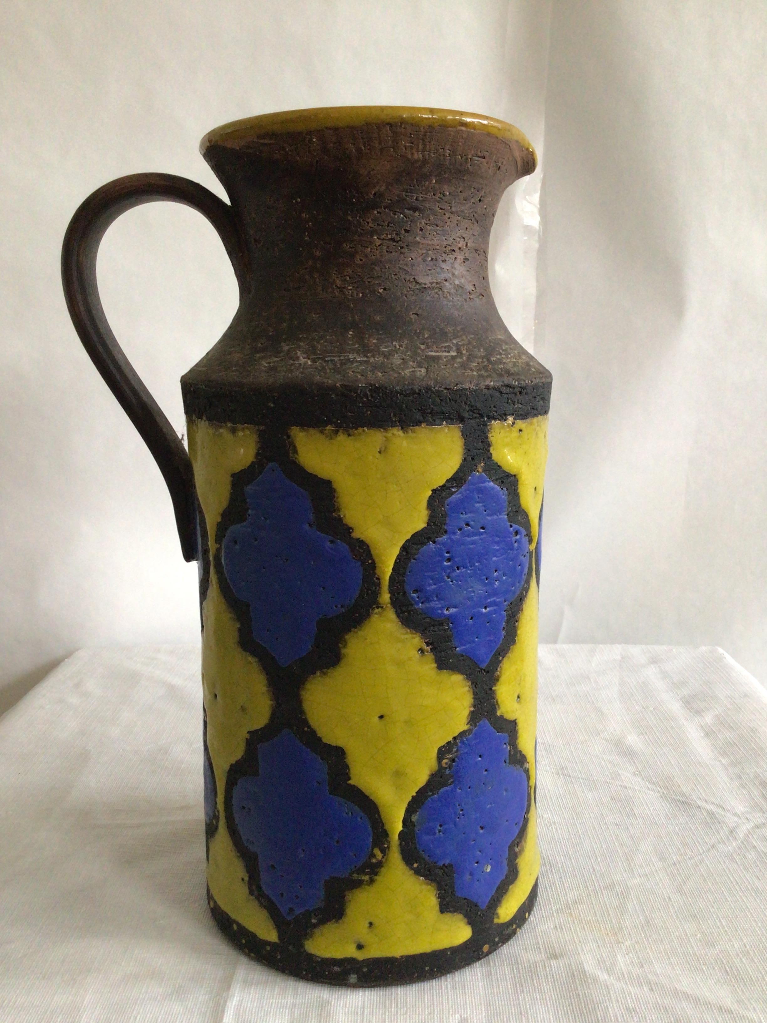 1960s Italian Painted Bicolor Pitcher/Jug
In the style of Aldo Londi for Bitossi vase in bright blue and striking yellow colorway. Resembles two color tiles 
Decoration gives a stained glass look that contrasts with the unglazed, rough