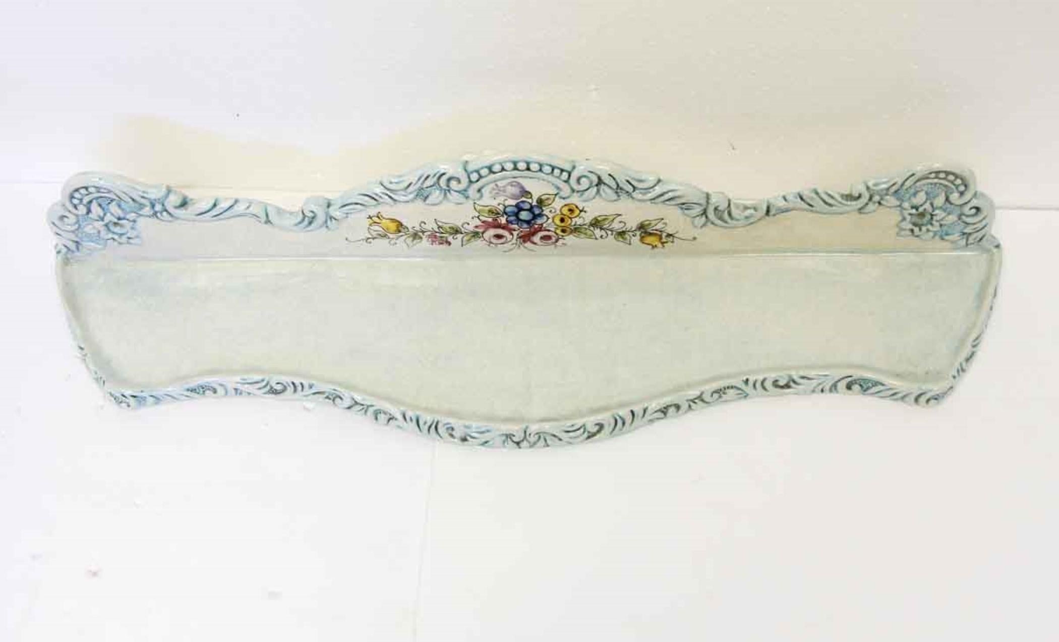 1960s blue and white decorative porcelain wall shelf featuring a crackled glaze and brightly colorful floral design. This can be seen at our 400 Gilligan St location in Scranton, PA.