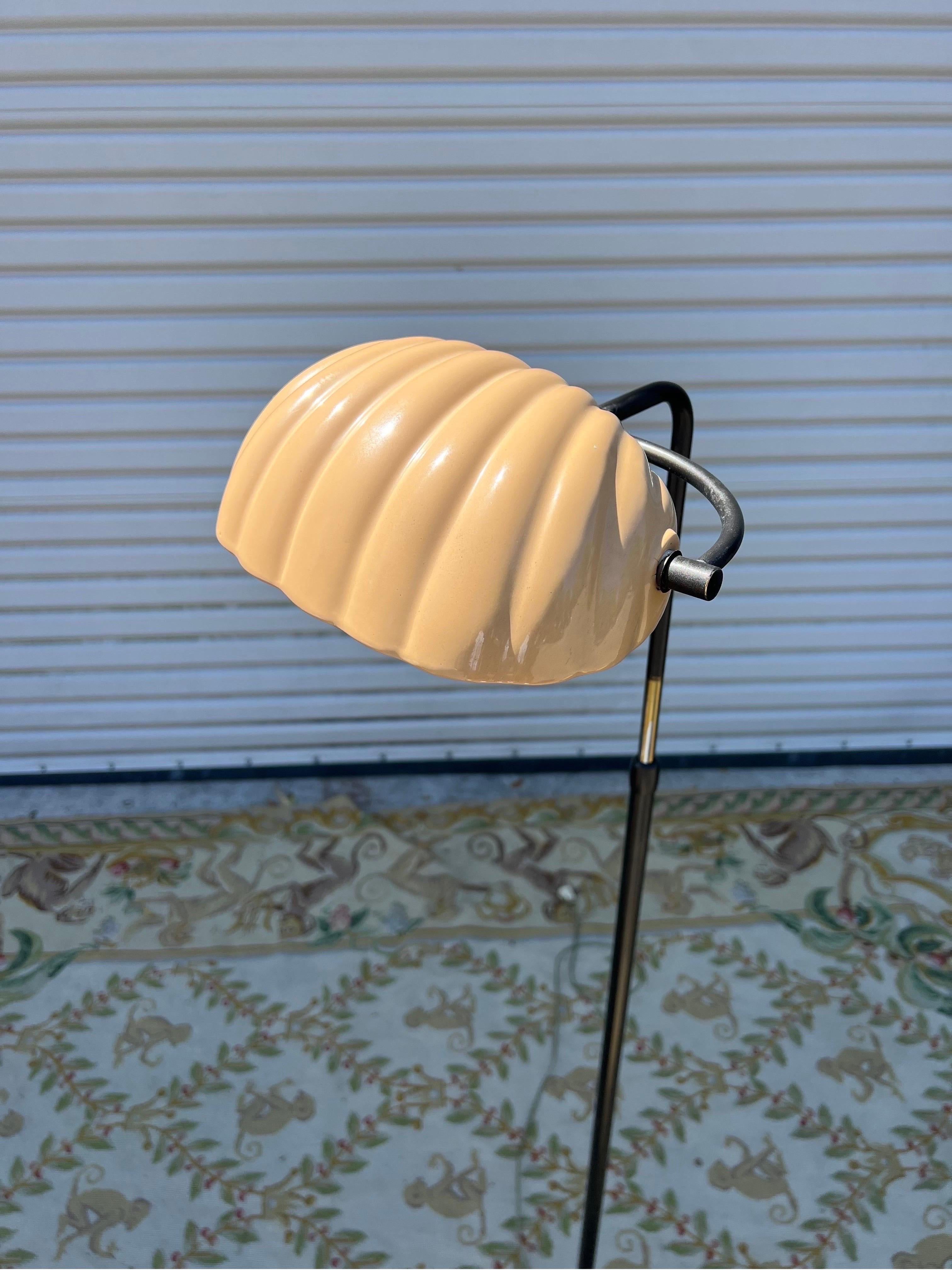circa 1960s Italian reading lamp. Pivoting ceramic scallop shell shade on adjustable height base in the manner of Tommaso Barbi. The porcelain shade reminds me of Farrow and Ball “Setting Plaster”, being a timeless neutral.