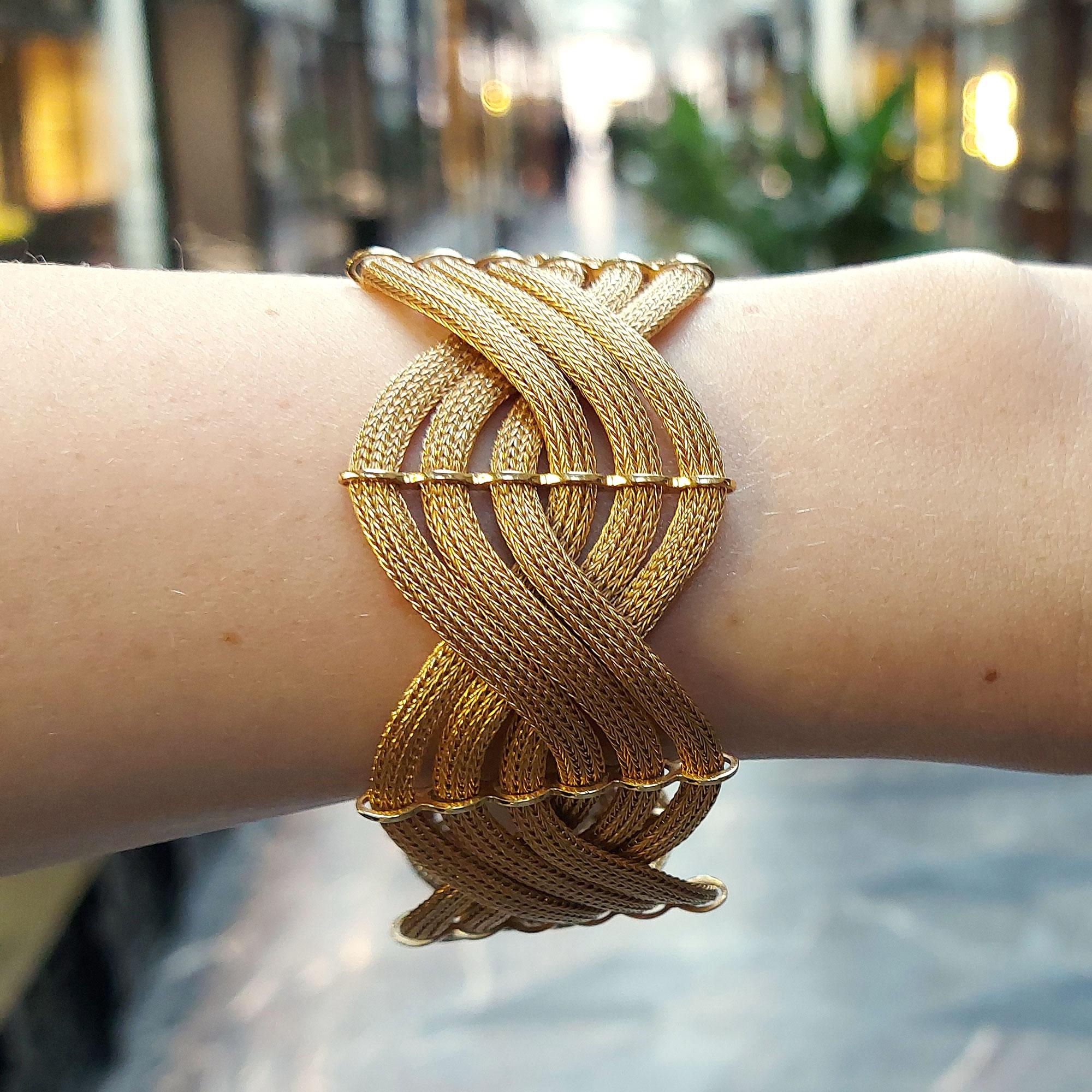 A sensational 1960's Italian braided bracelet set in 18k rose gold. This piece is designed as a double plait of six spiga ropes - three ropes going each way. These are held into place by six fine gold spacers surrounding each rope individually.