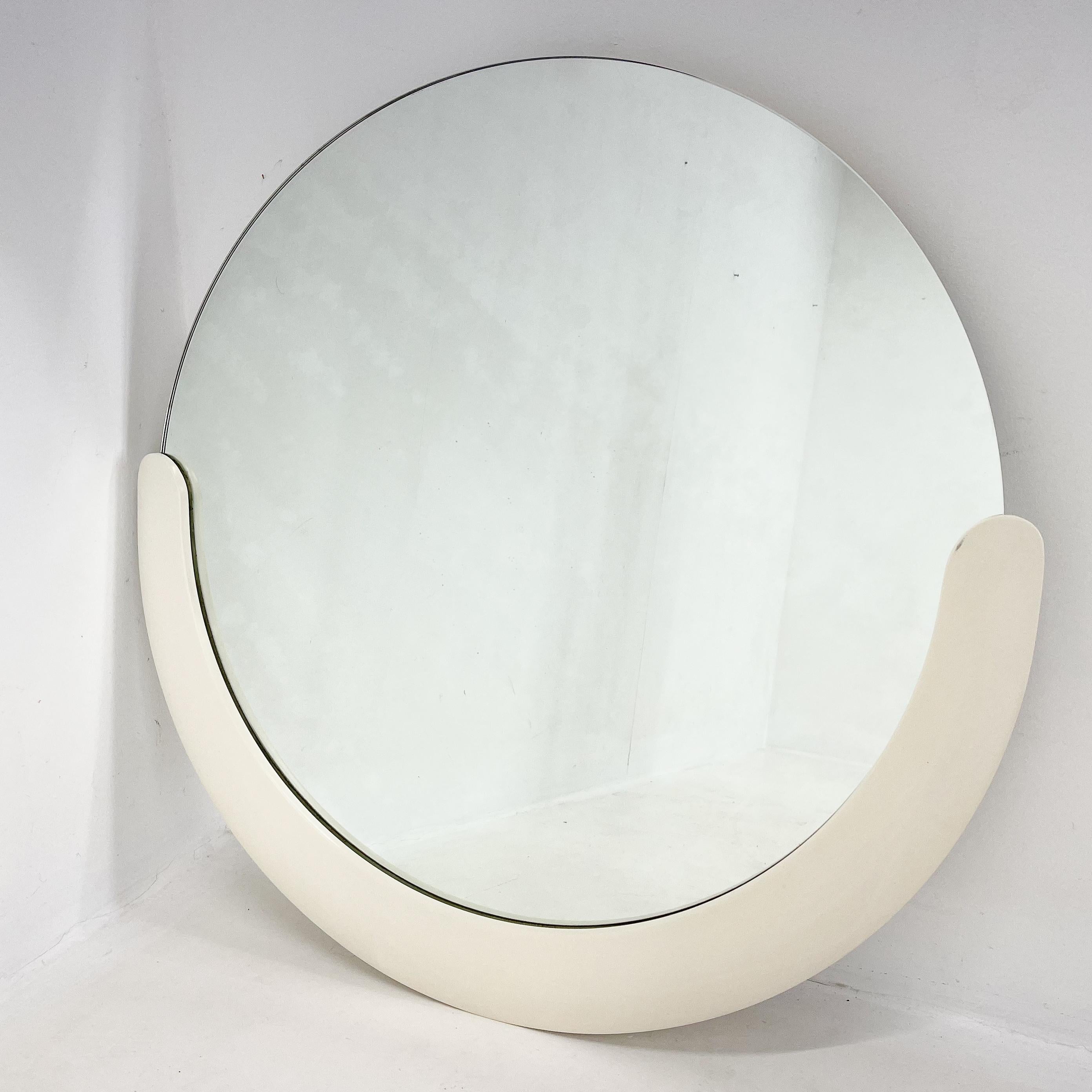 Round wall mirror with lacquered wood decor. Made in Italy in the 1960's.