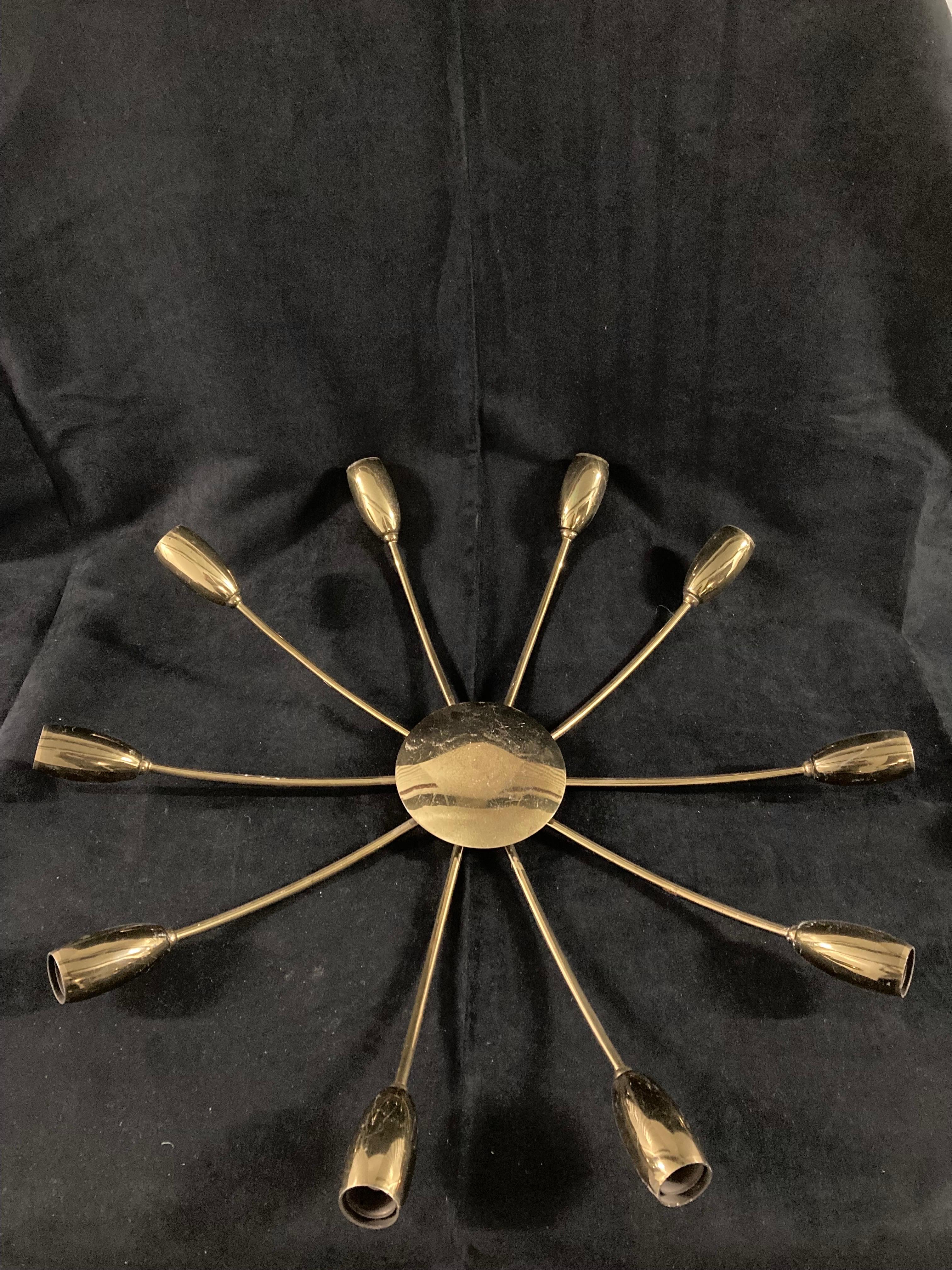 1960s Italian Starburst Wall or Ceiling Light Attributed to Stilnovo.

Gilt metal.

Max width 64 cm.
Max depth 12 cm.
Central disc 14 cm wide.

Milanese lighting company Stilnovo was founded in 1946 by Bruno Gatta, and its participation at the Milan