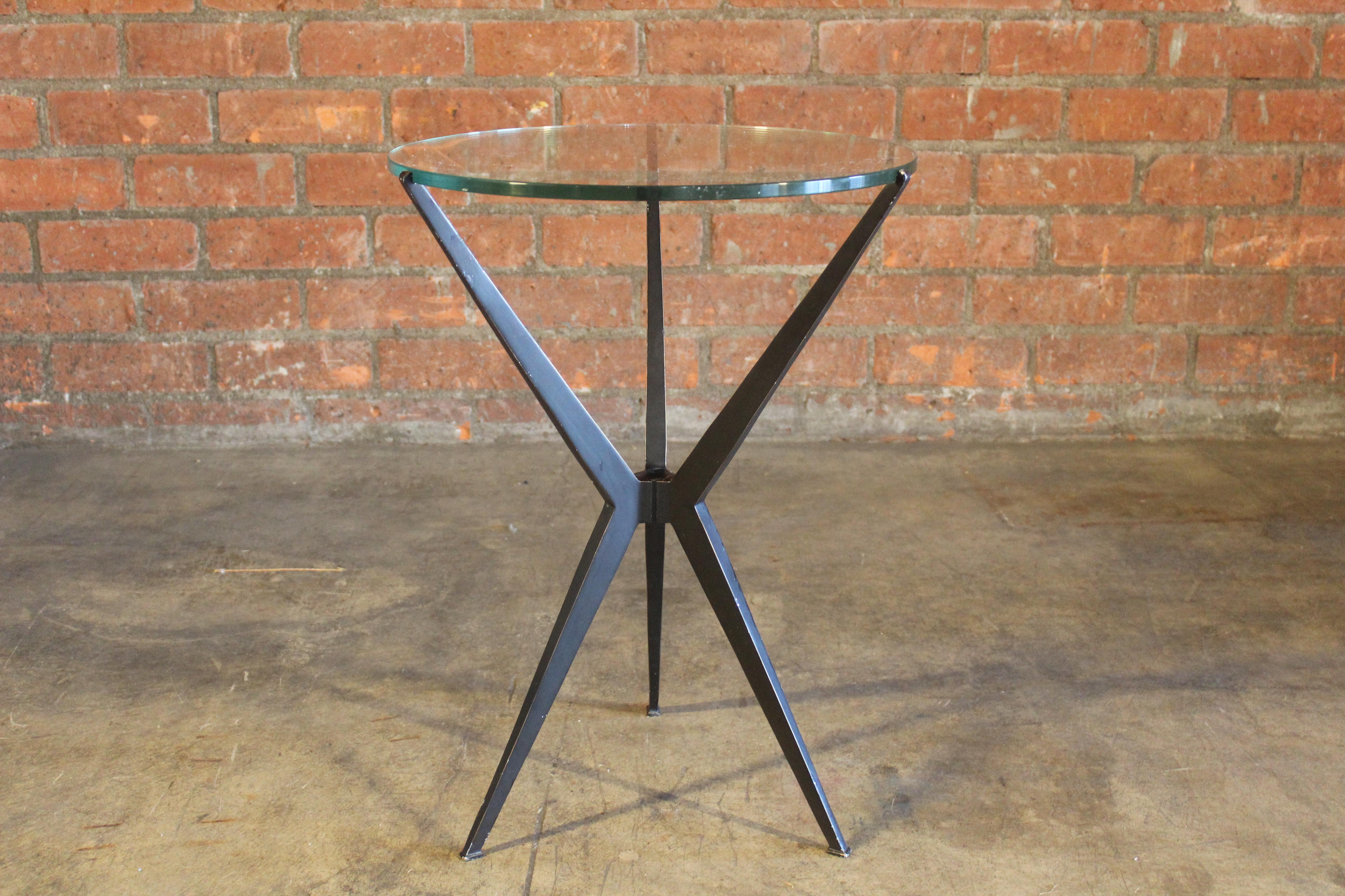 A vintage steel side table with glass top, Italy, 1960s. In good condition, the painted steel base shows some minor paint loss. The glass top is original to the table and has hairline scratches.